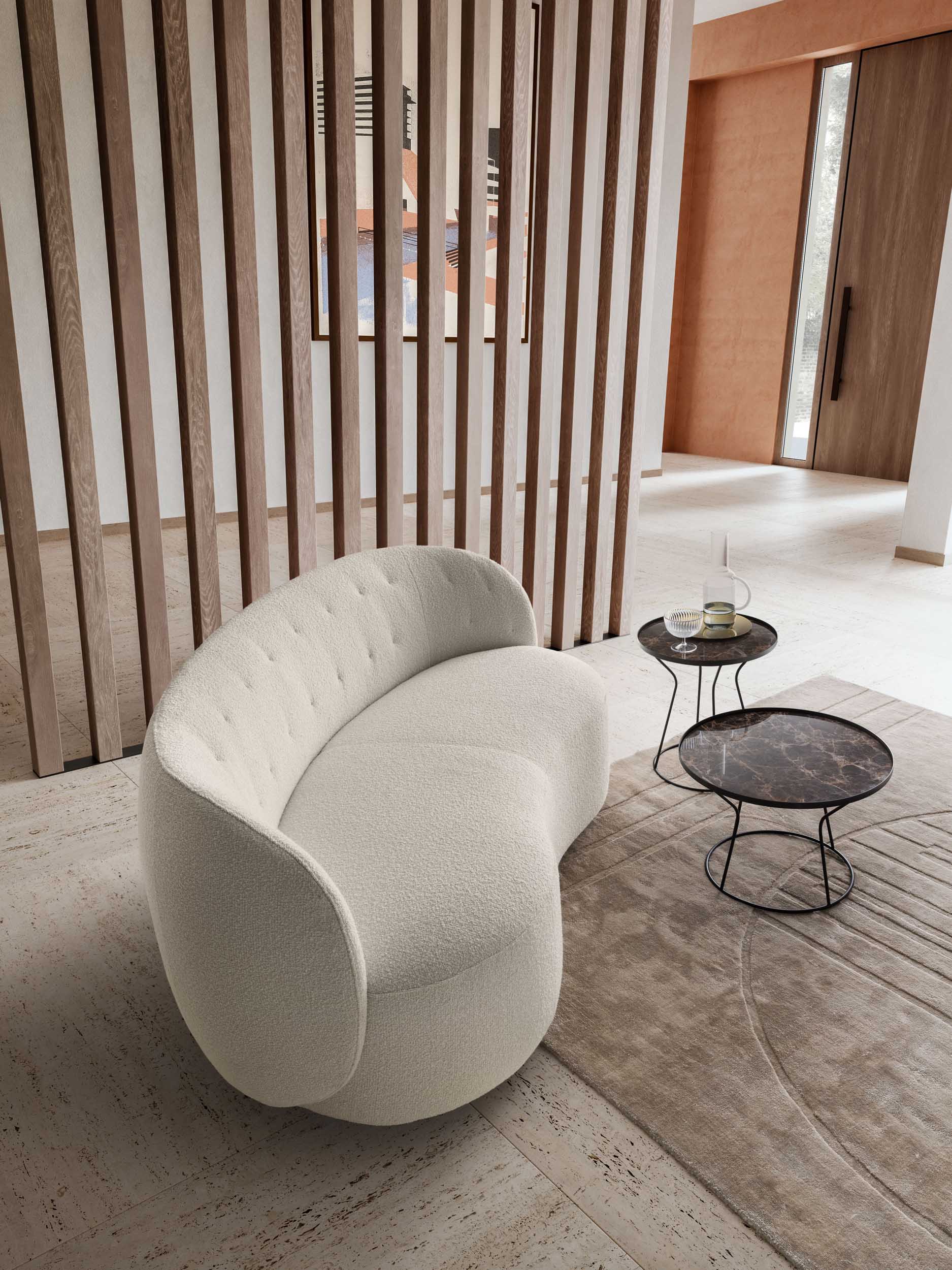 Seat of a modern curved loveseat in a warm-toned setting