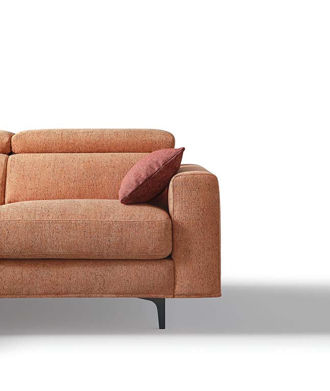 Detail of the square armrest of a modern sofa with high feet