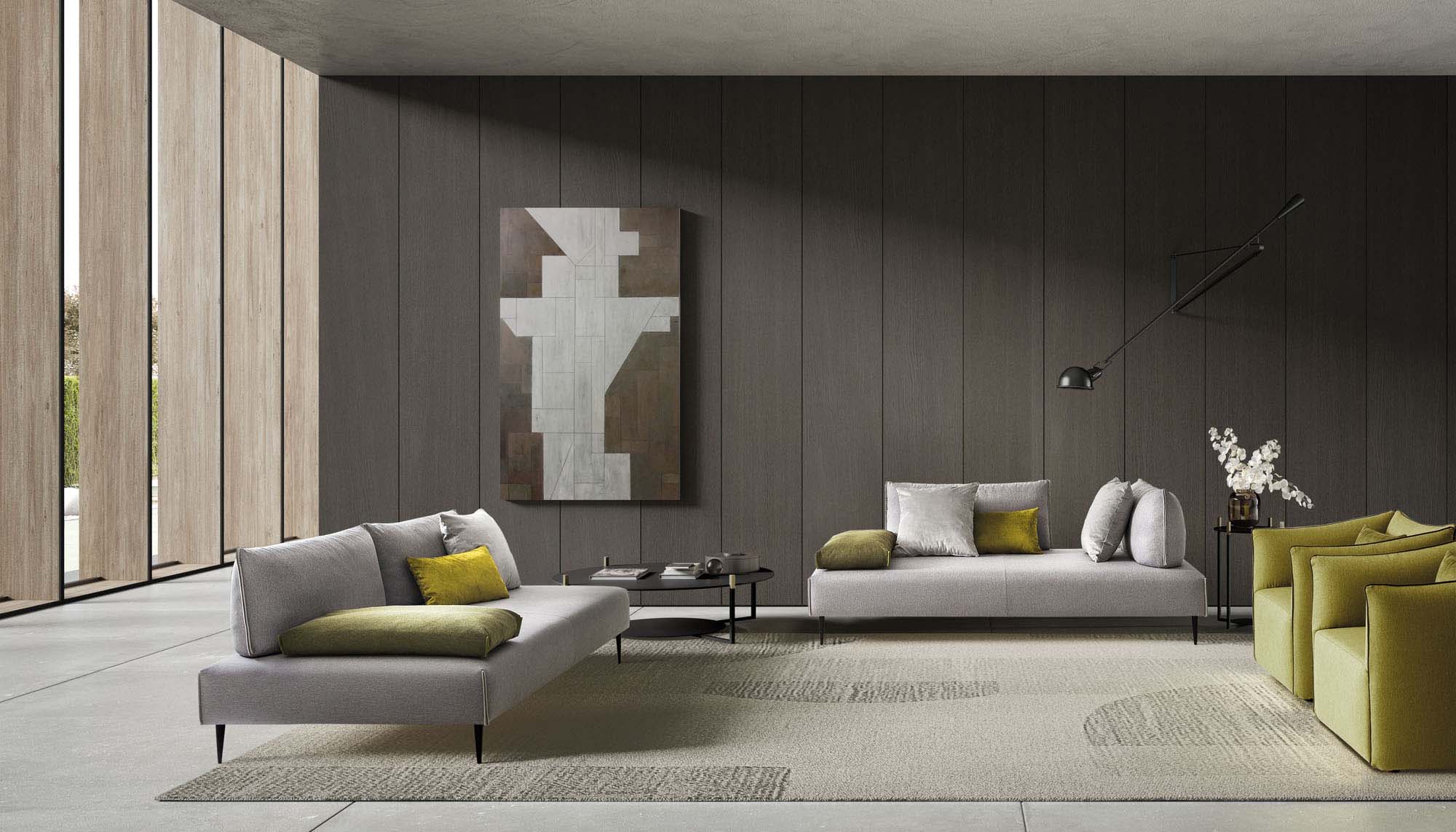 Modern living room in gray tones furnished with Bacio Light sofas with thin legs and sliding backrests.