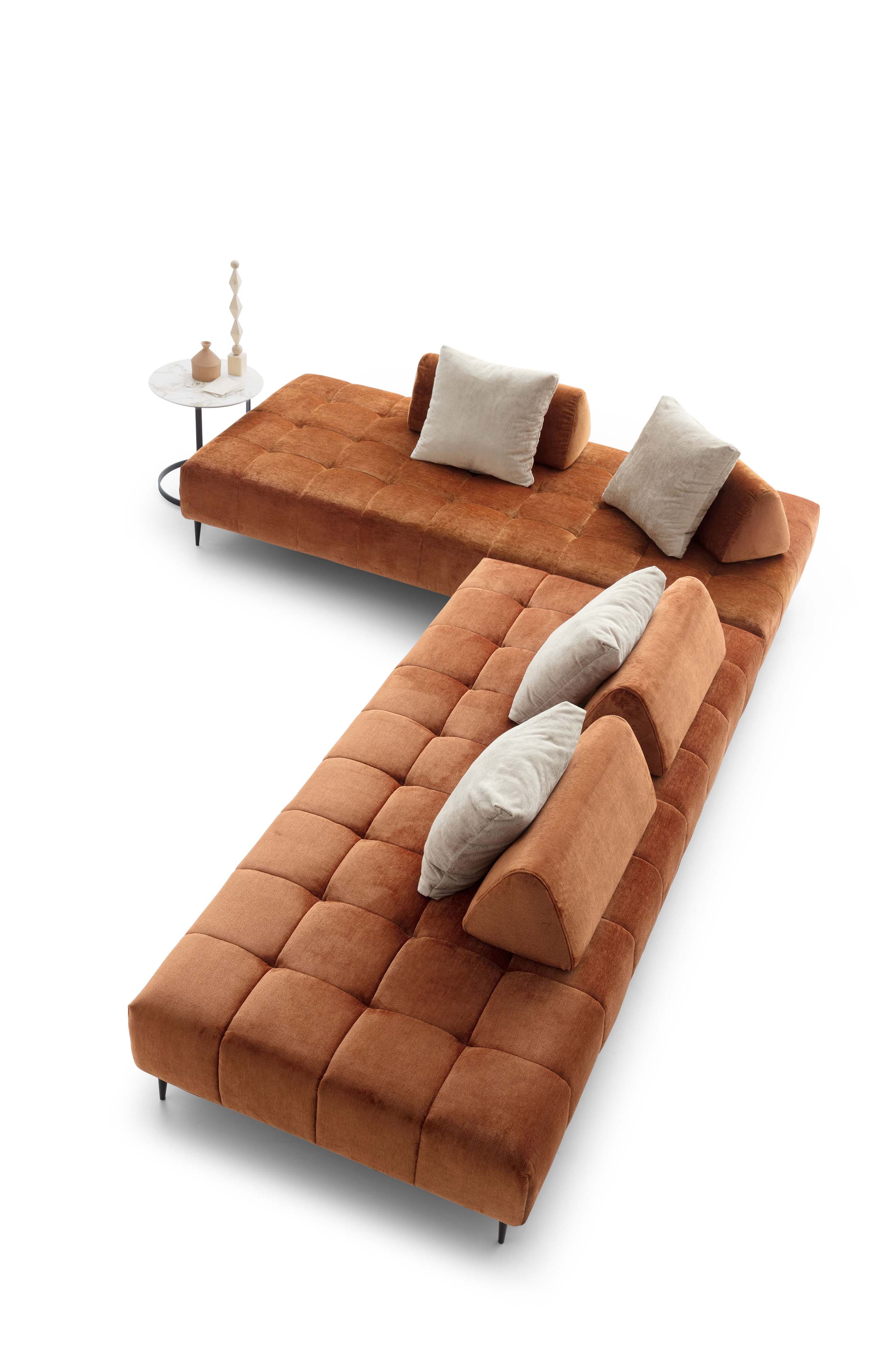 Overhead view of a modern and design quilted sofa with high legs and sliding backrest