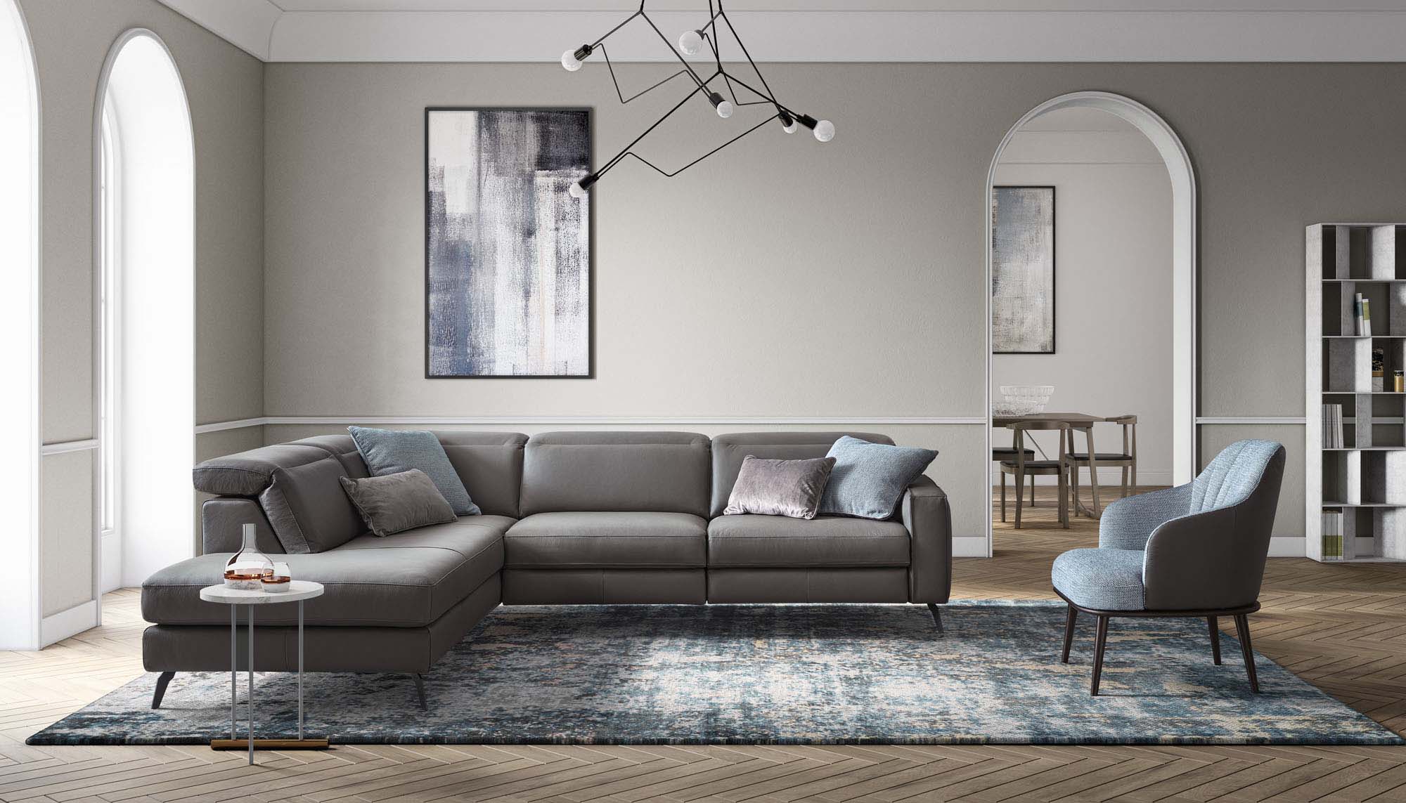Modern living room furnished with a grey leather sofa paired with a light blue armchair.