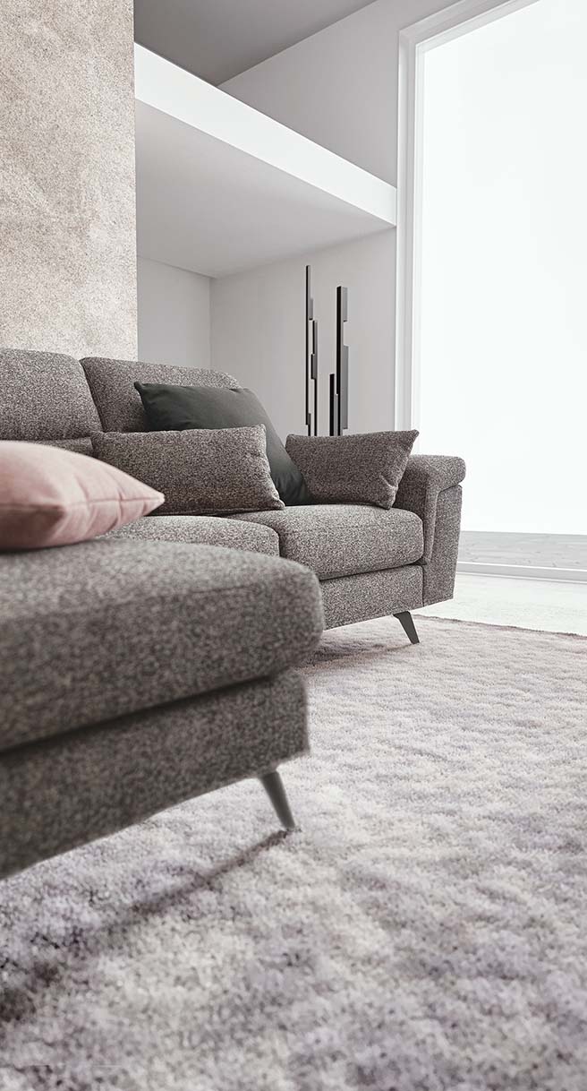 Detail of the chaise longue of a gray fabric sofa