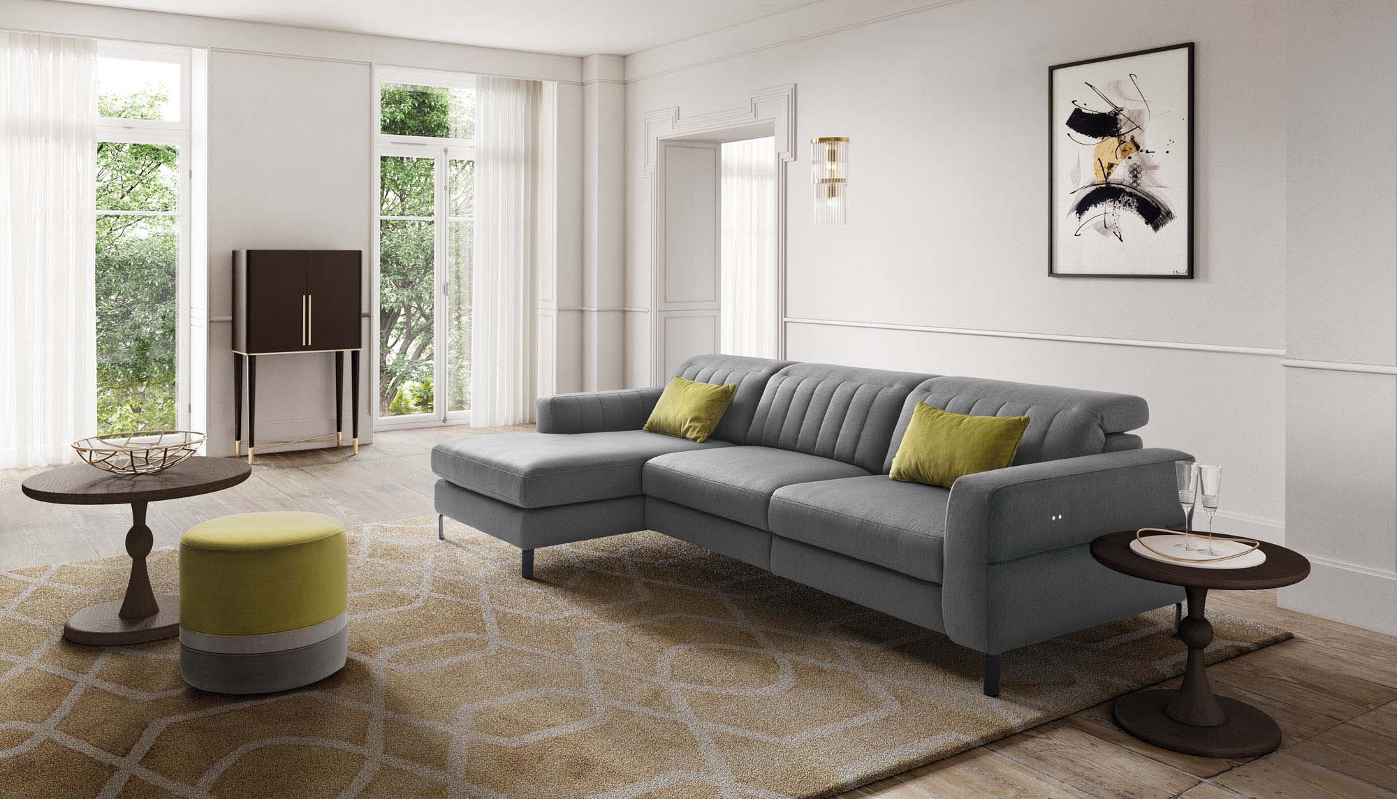 Grey fabric sofa with chaise longue and adjustable headrests.