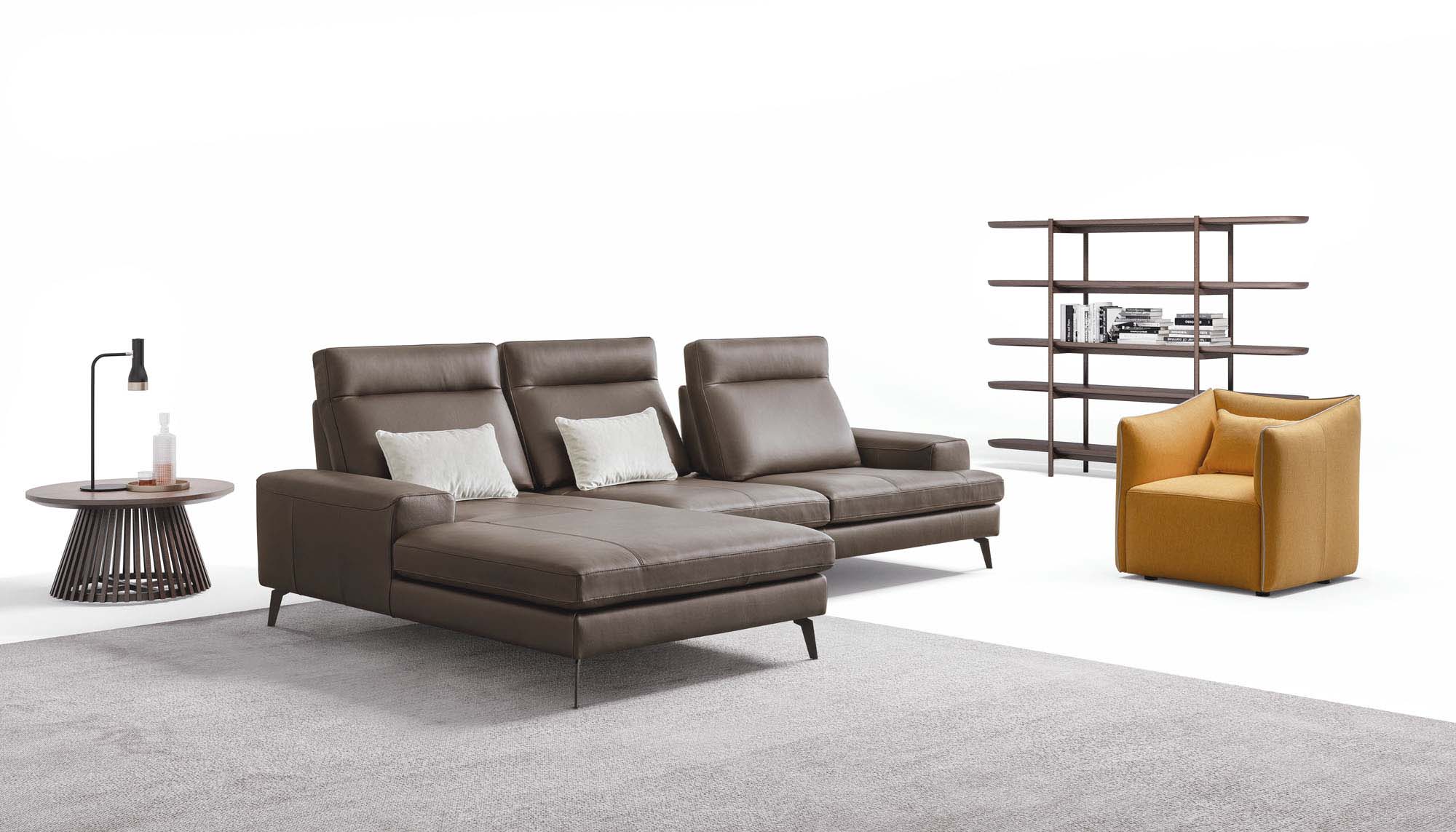 Brown leather sofa configured with a large chaise longue and high, thin legs