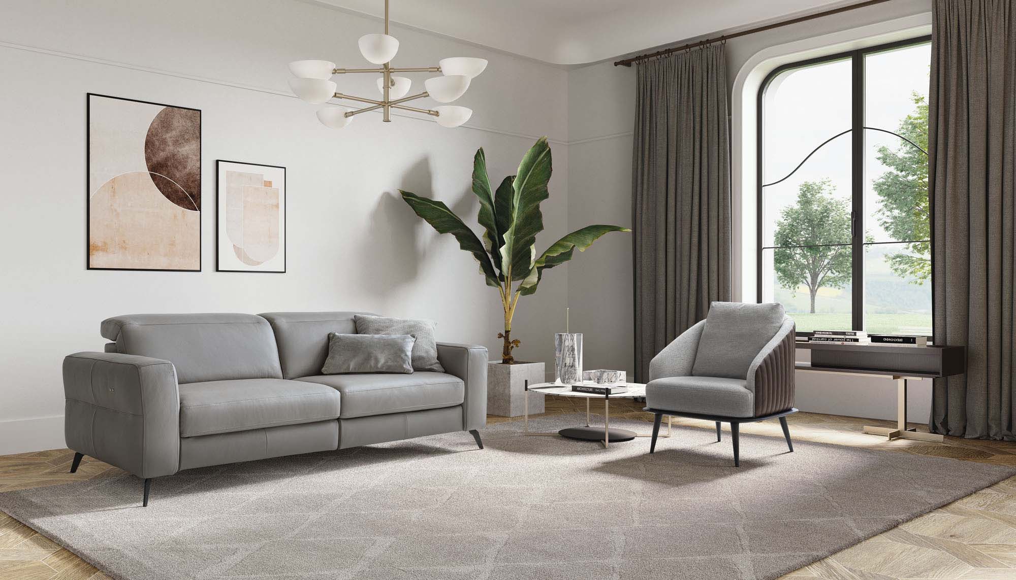 Living room furnished with a grey leather sofa with adjustable headrests, paired with an armchair