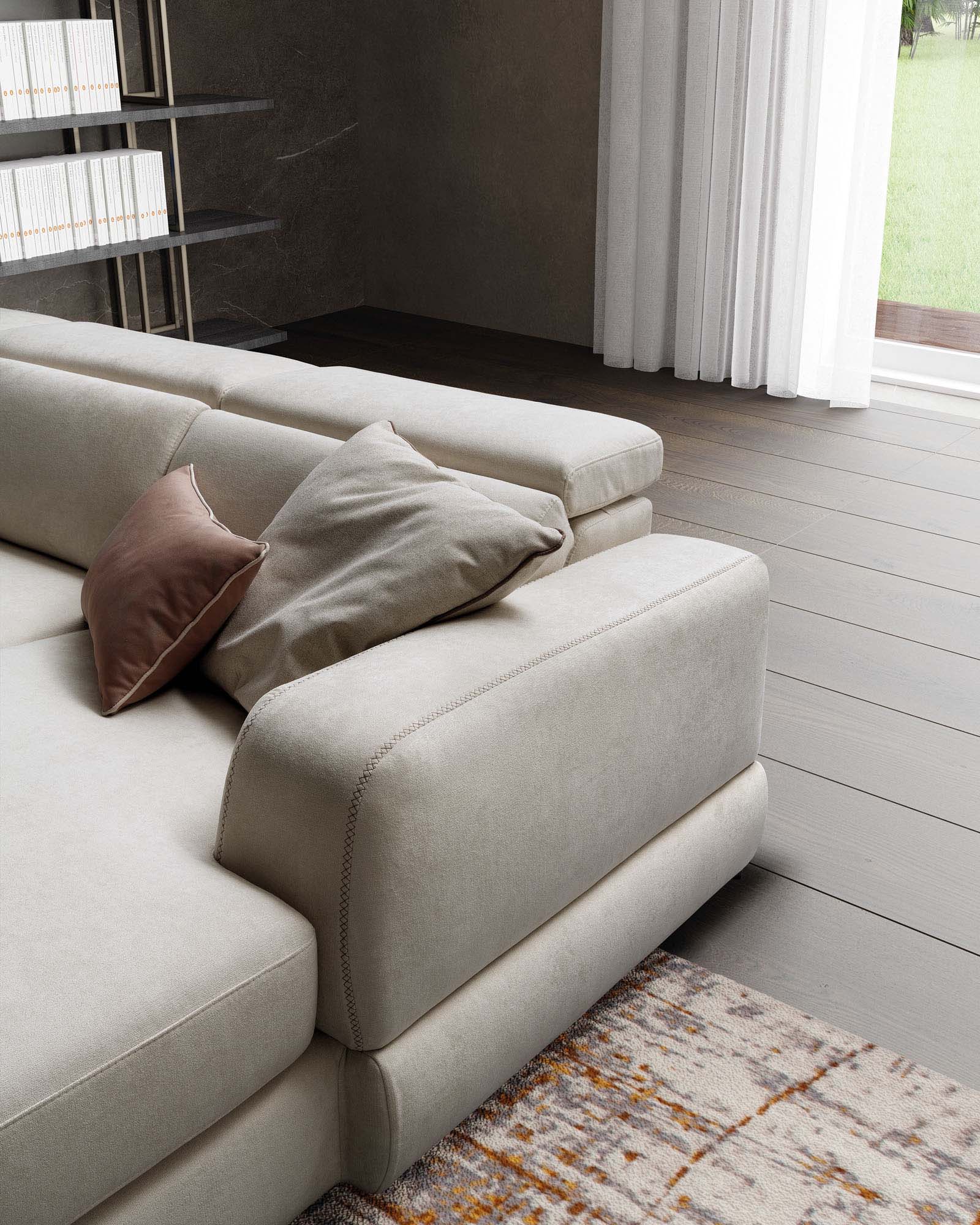 White sofa with wide armrest and visible stitching