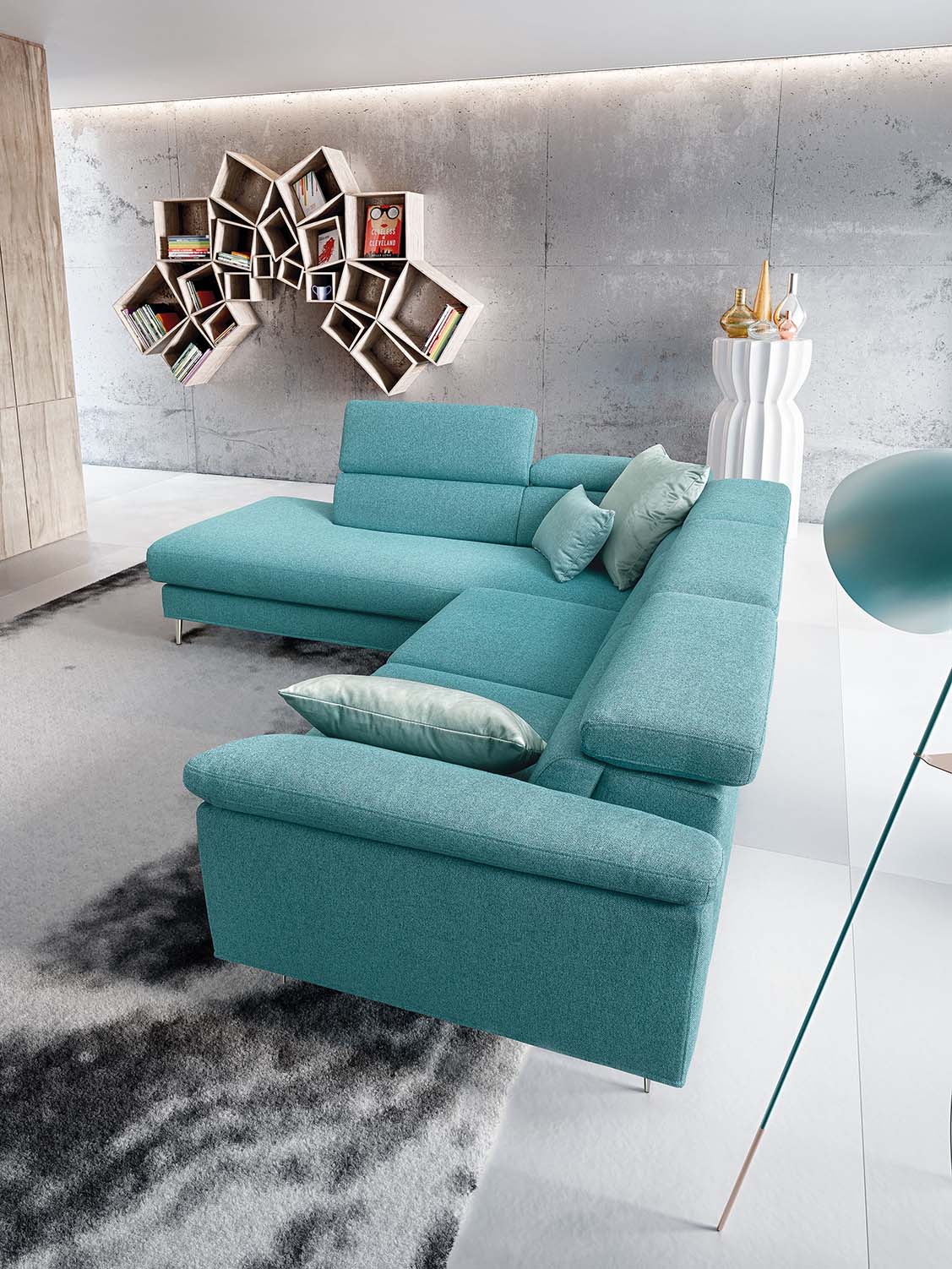 Side view of a modern sofa with high feet in a corner composition with a backrest that runs along the perimeter