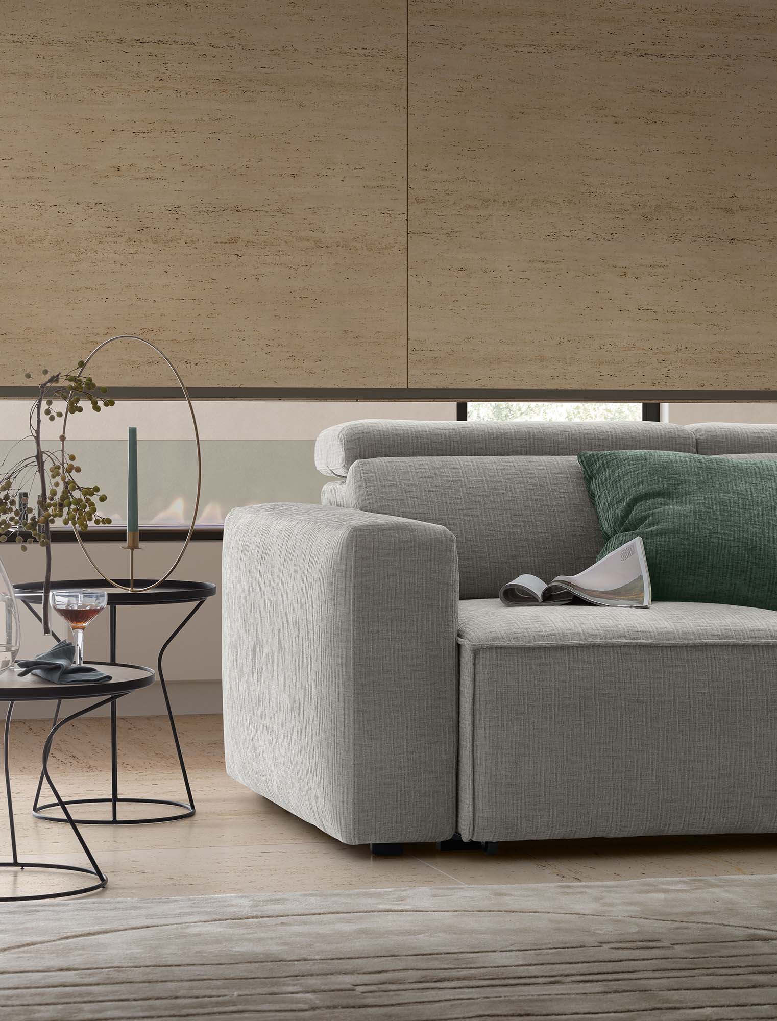 Detail of the Hill sofa armrest with closed headrest. Set in a modern living room