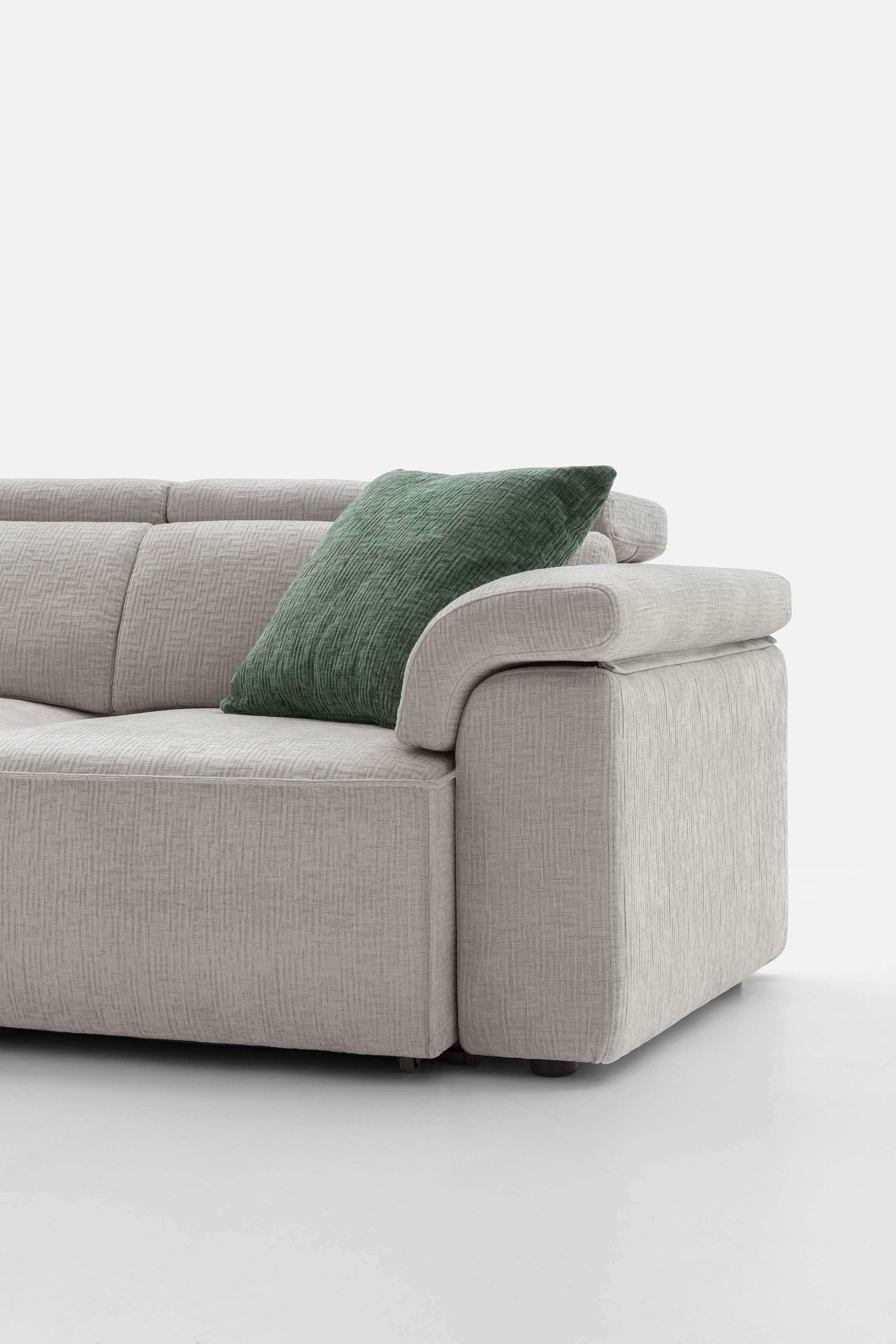 Rounded armrest of a gray fabric sofa