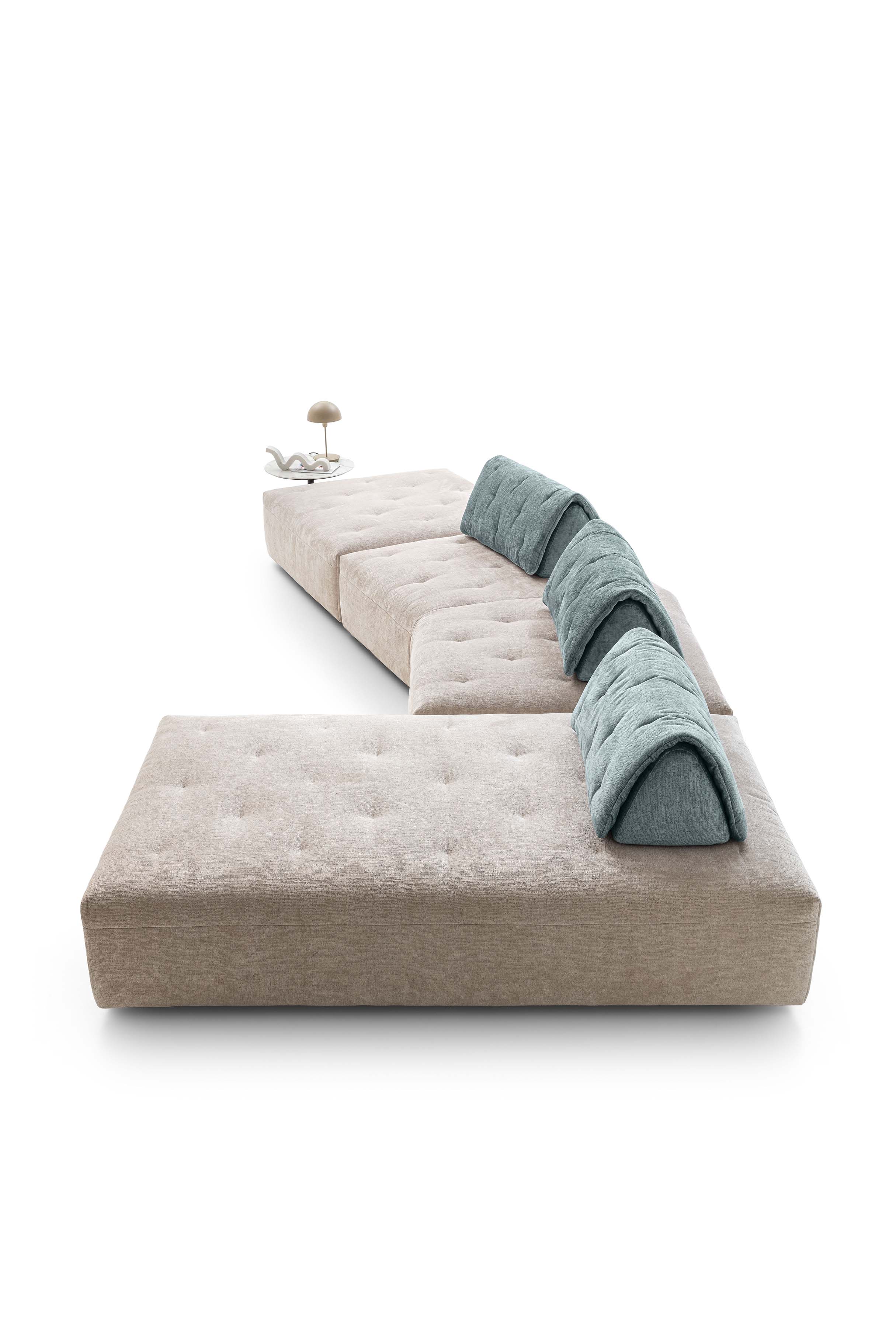 Light-colored sofa with quilted seats and sliding backrests to adjust seat depth. Chaise lounge composition.