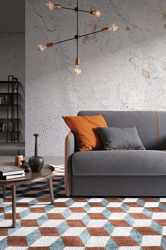 Detail of the seat and piping of a sofa placed on a rug with three-dimensional textures