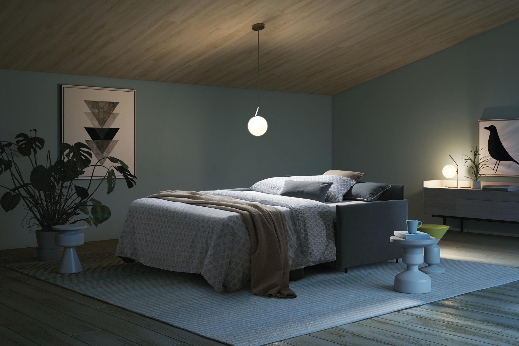 Naxos sofa opened in comfortable double bed mode with blankets and pillows in an attic floor