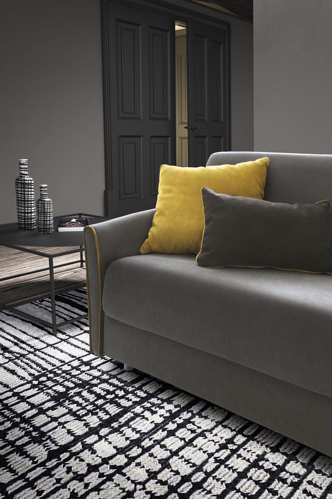 Detail of the seat of a sofa with slim and space-saving armrest and low feet