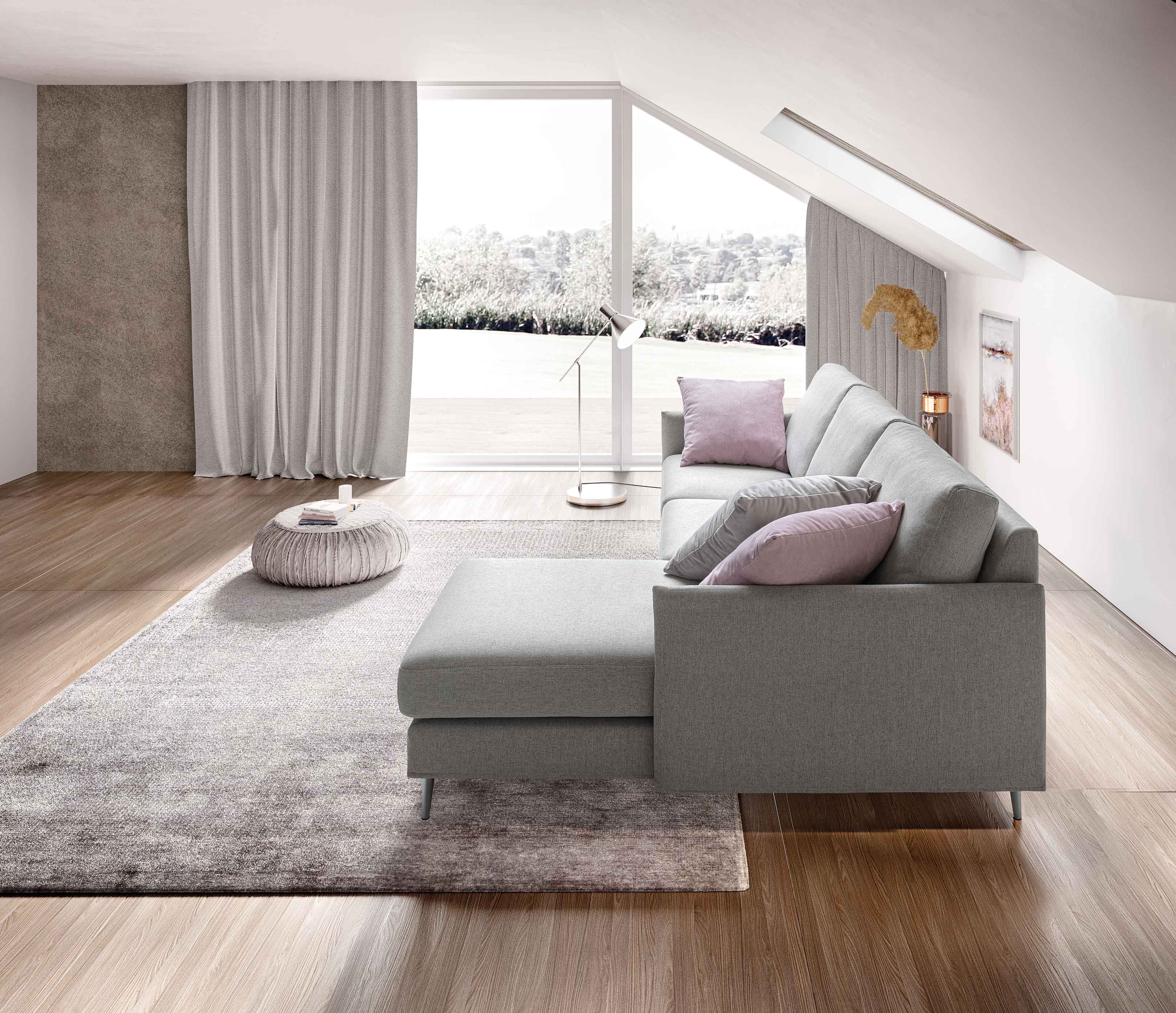 Living room with wooden floor furnished with a gray peninsula sofa