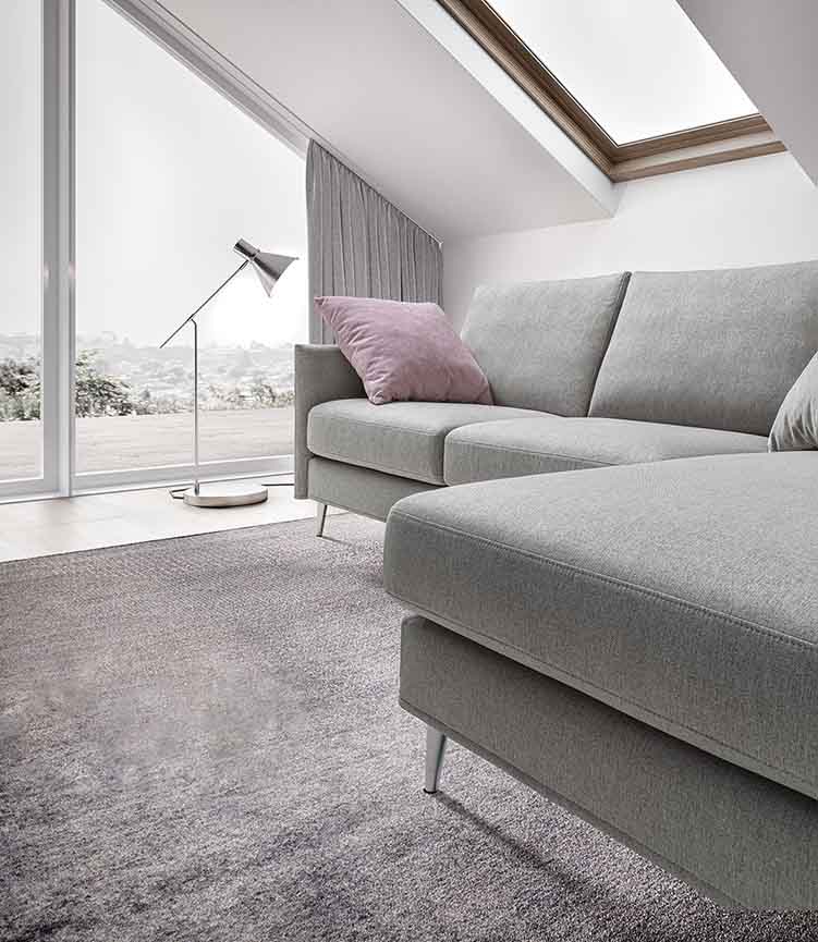 Modern gray sofa with pink cushion and completely removable and washable coverings