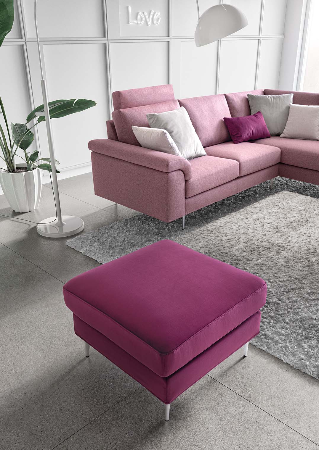 Pink sofa in a corner version with a headrest cushion added to the backrest