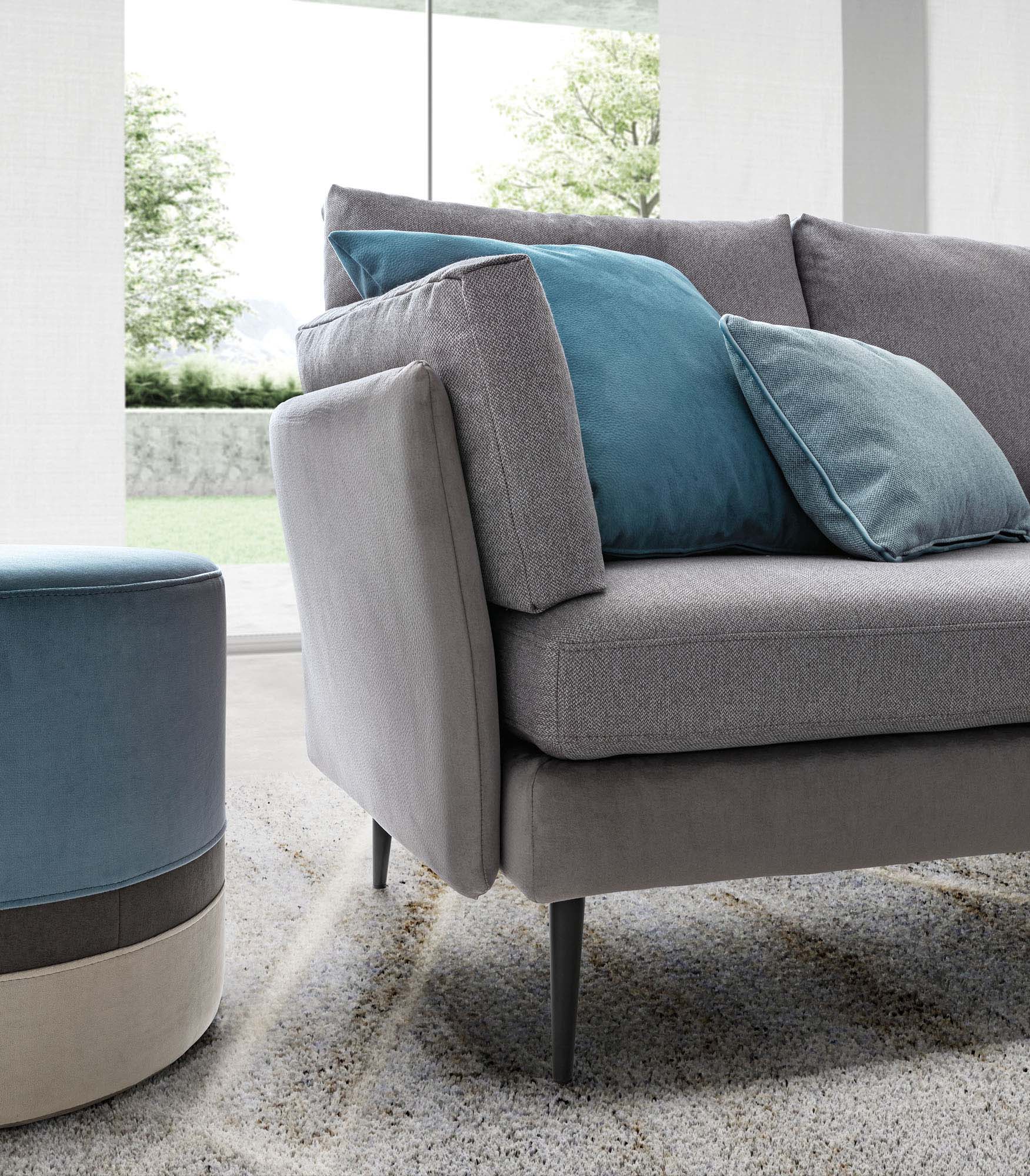 Sofa with high legs and thin cushion armrest