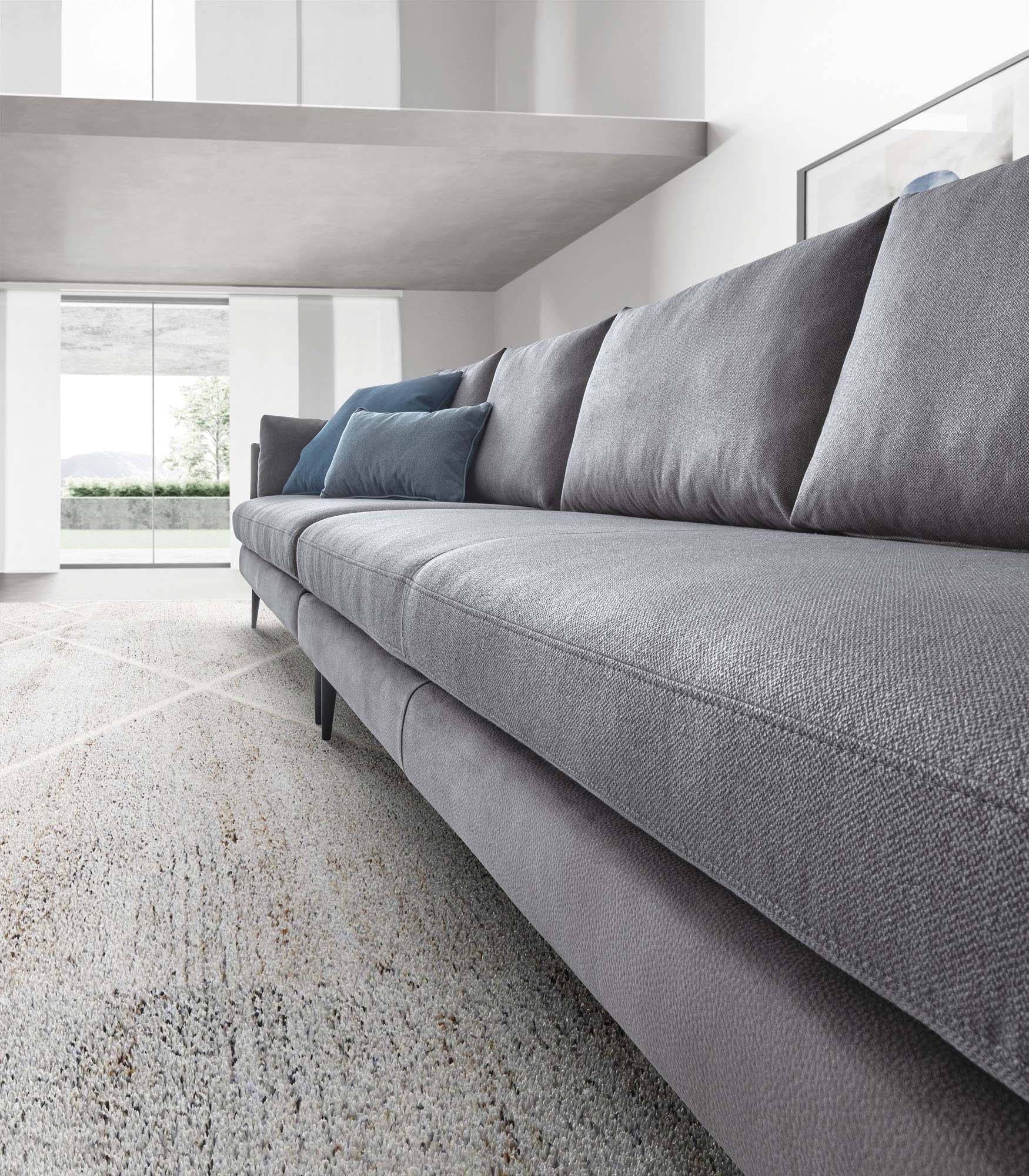 Linear grey sofa with blue cushions