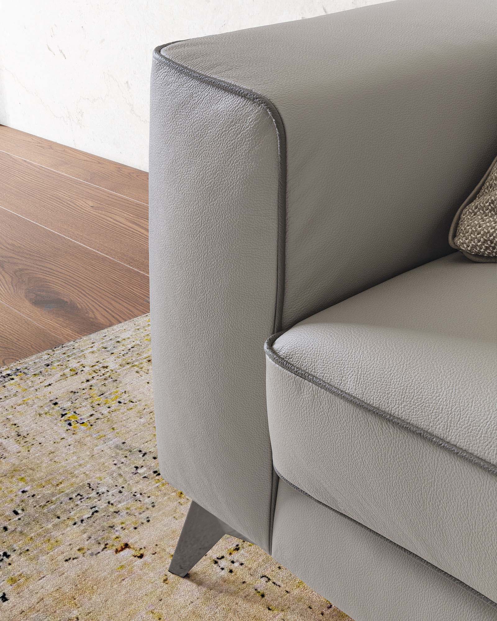Comfortable sofa with a cozy armrest and modern legs