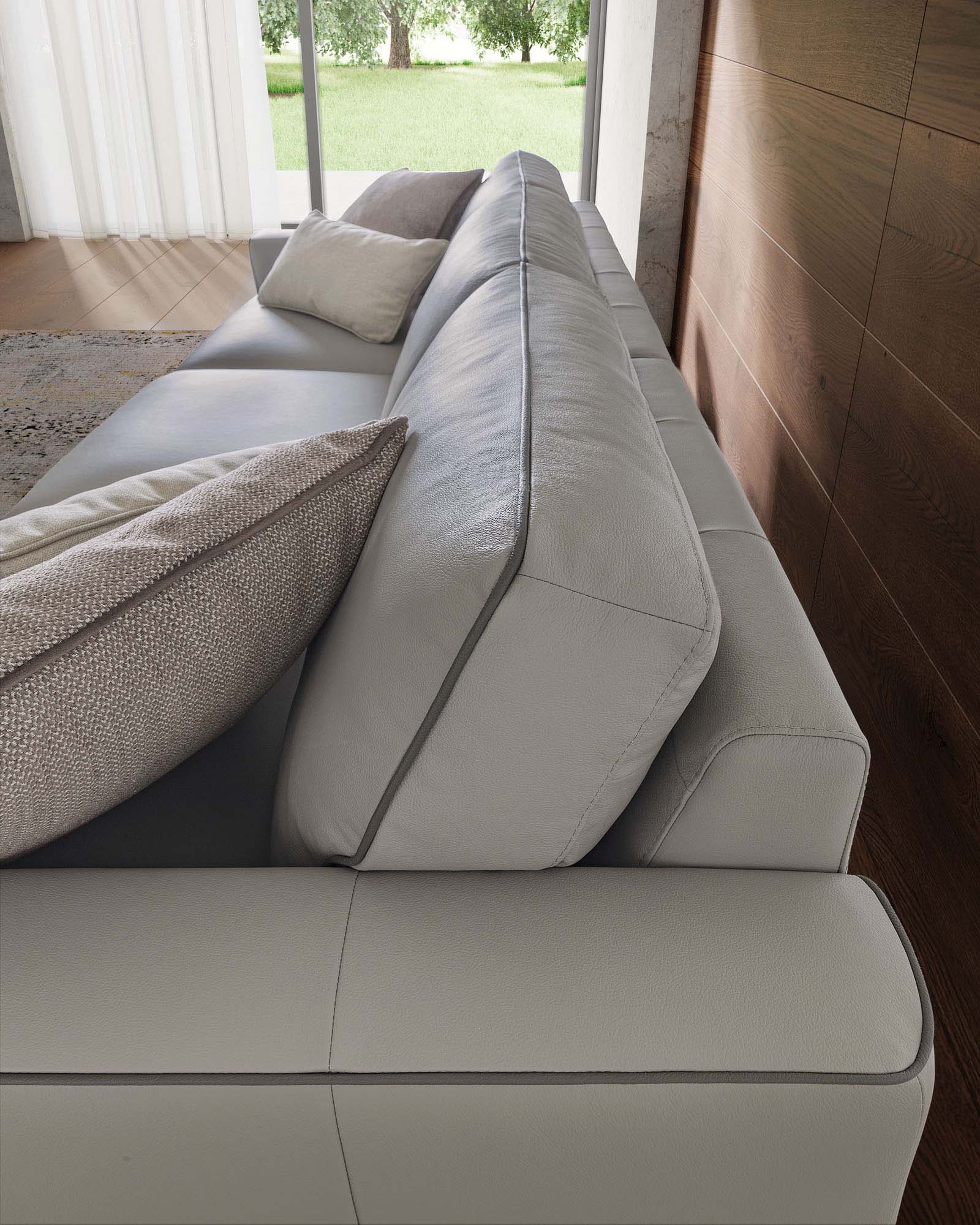 Light gray leather sofa with contrasting dark gray trim