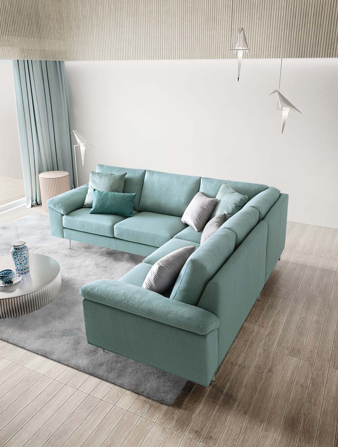 Modern sofa with water green upholstery and contrasting gray and petrol green cushions