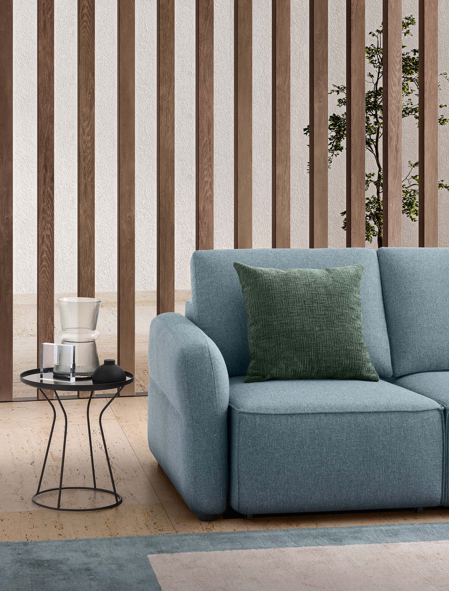 Detail of the monocoque seat of the Soho sofa in light blue fabric with pull-out seats