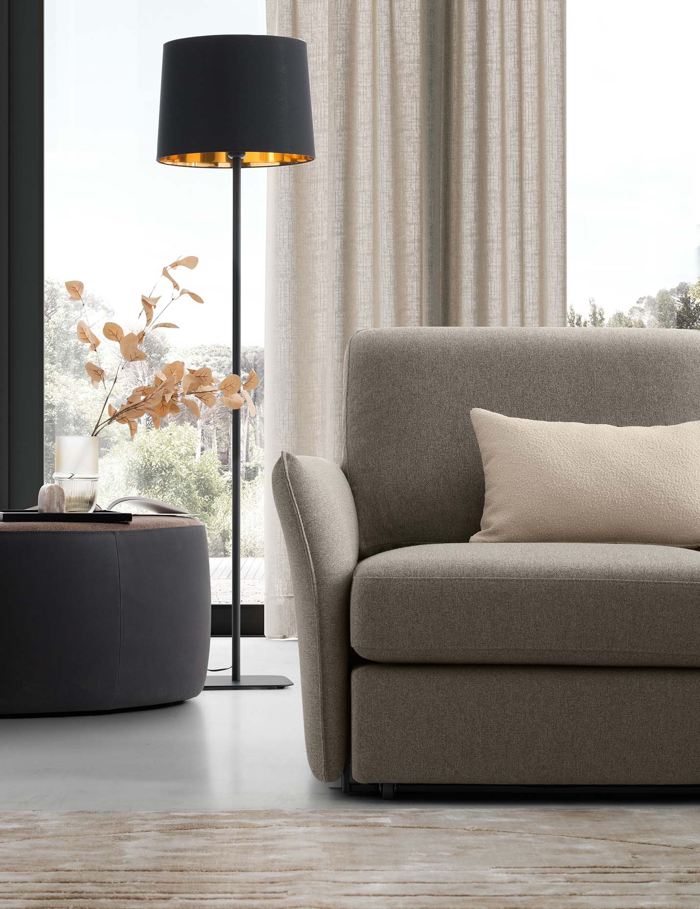 Seat of a gray sofa with a very slender and space-saving armrest and very low feet
