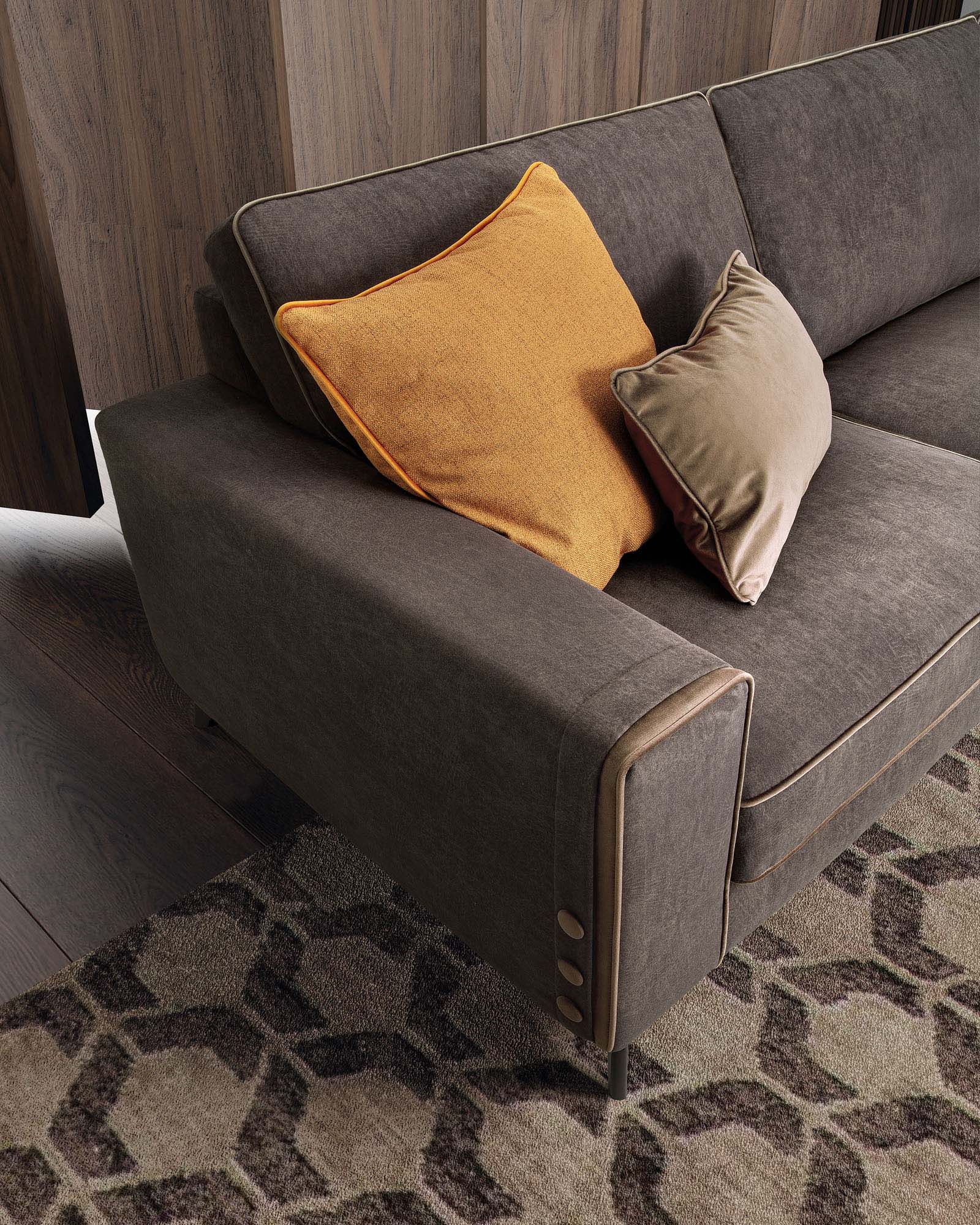 Close-up of the armrest with trim and buttons on a brown sofa.