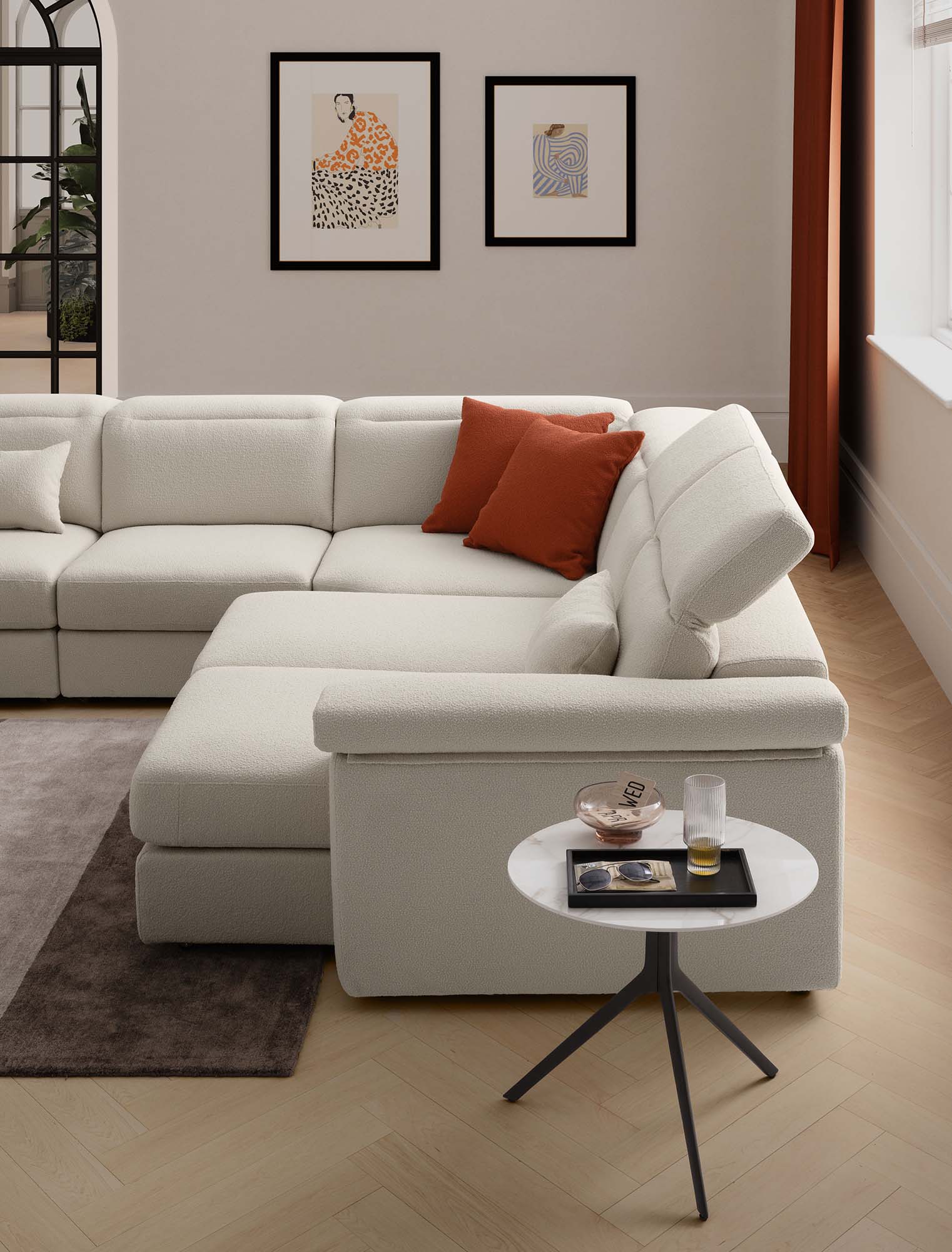 Corner sofa composed of open pull-out seats, headrests adjusted to support the head. Elegant white color.