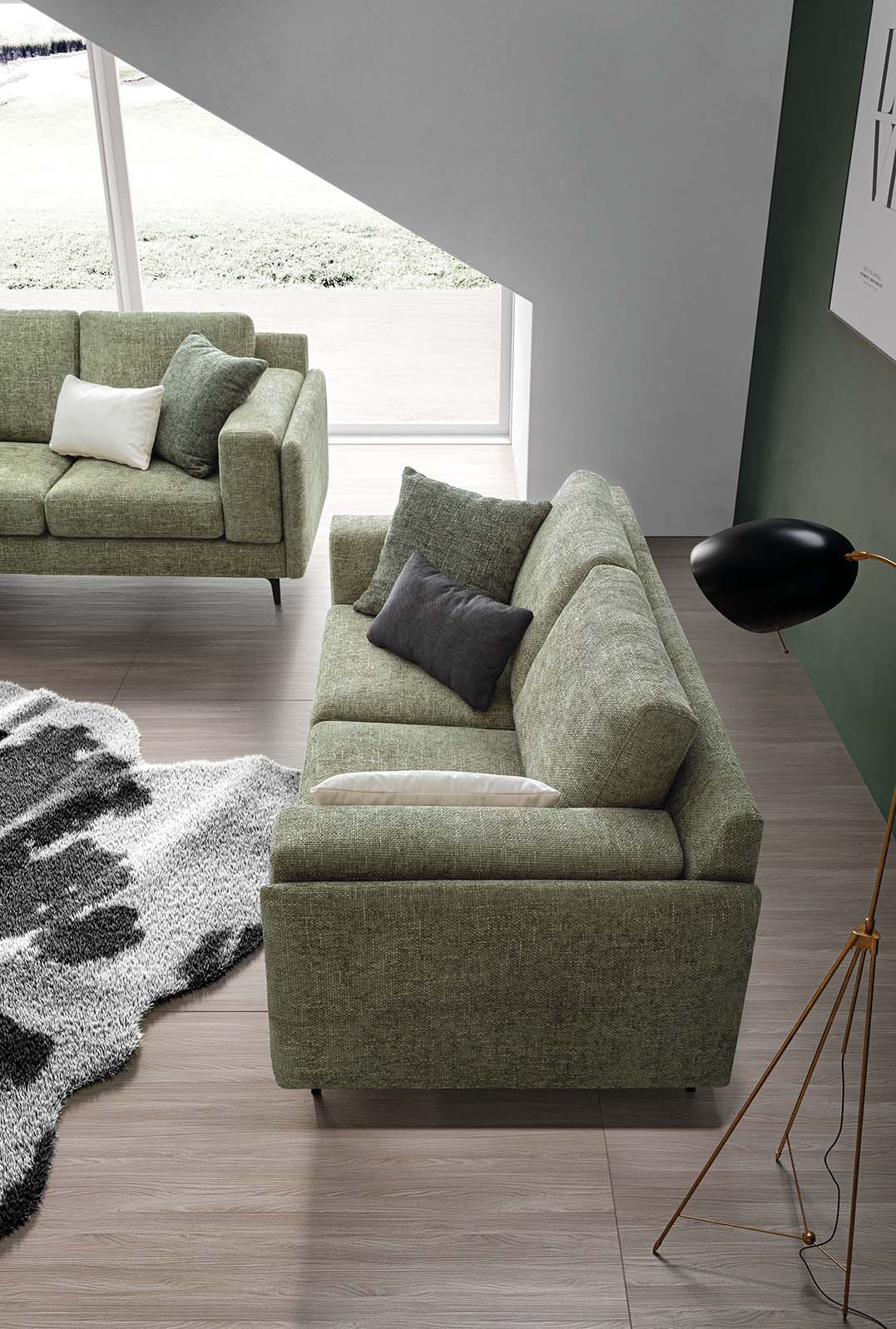 Top view of a living room composed of two green two-seater sofas with contrasting cushions