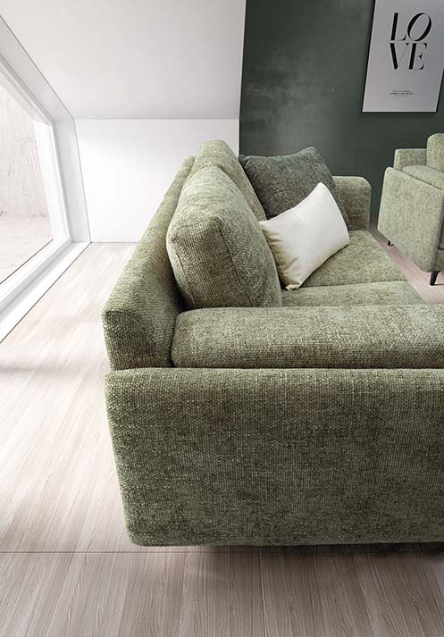 Side view of the Tecla sofa: wide armrest for placing remote control and cell phone