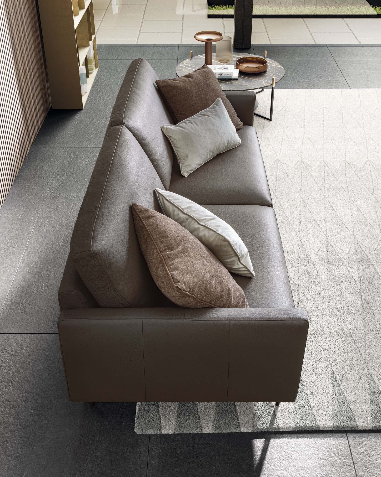 Two-seater brown leather sofa.