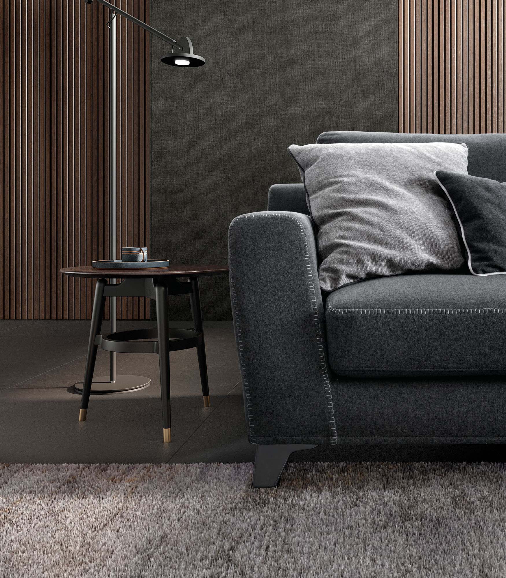 Gray sofa with silver stitching and modern legs