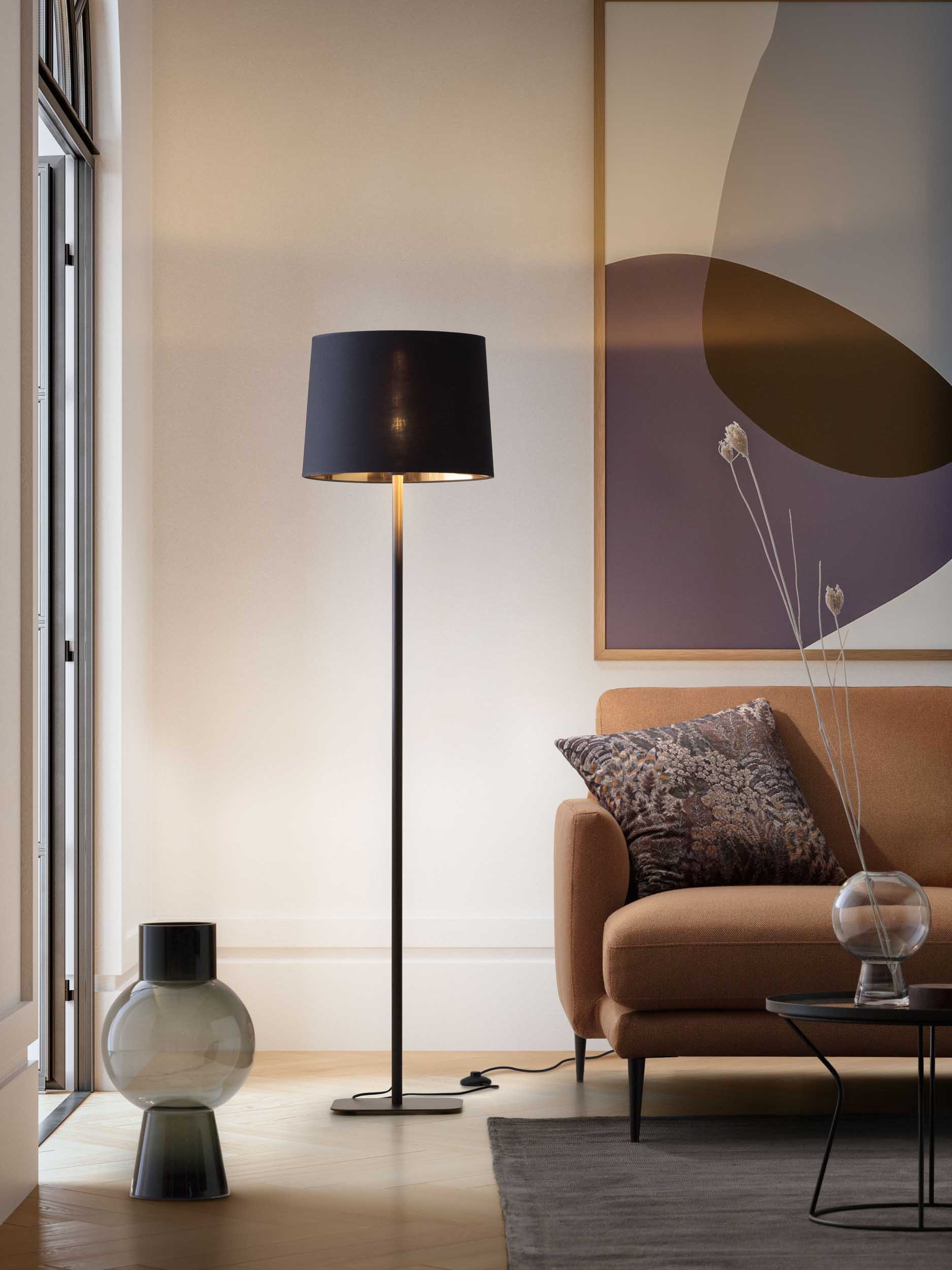 Floor lamp with black lampshade in a colorful modern living room