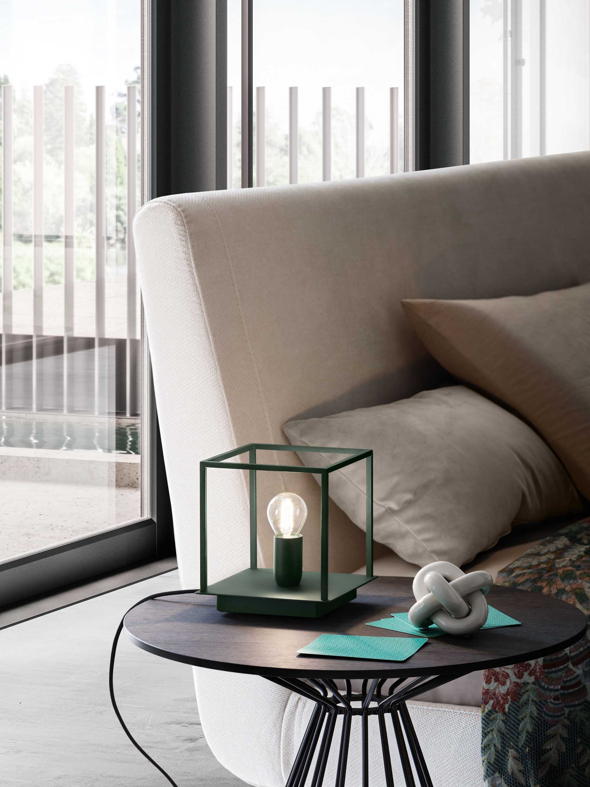 Table lamp with green painted metal structure and visible bulb.