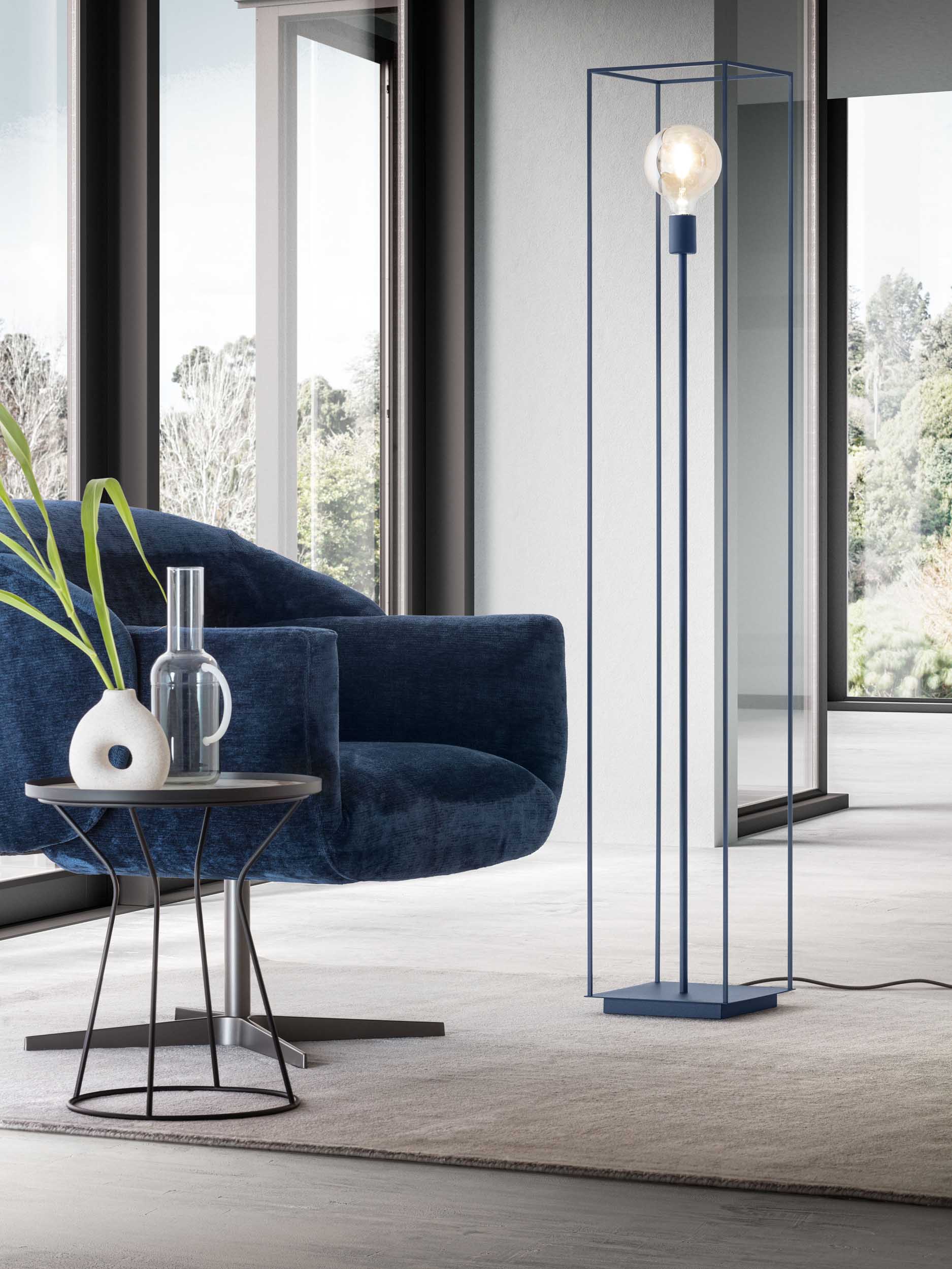 Cage-style floor lamp in Ocean Blue with visible bulb in a modern living room