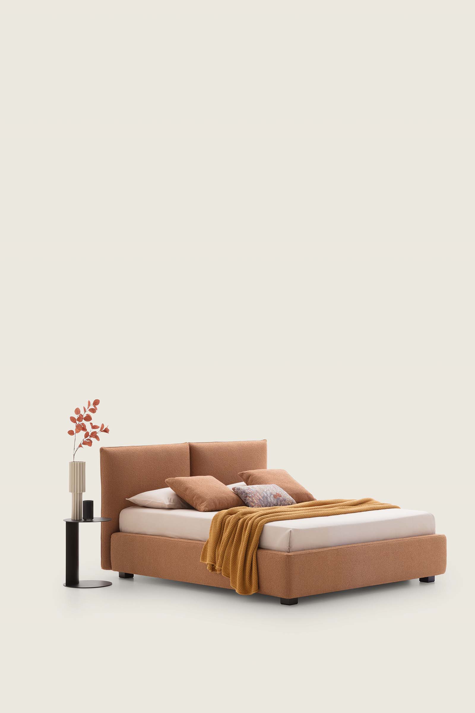 Low bed with coral-colored upholstery
