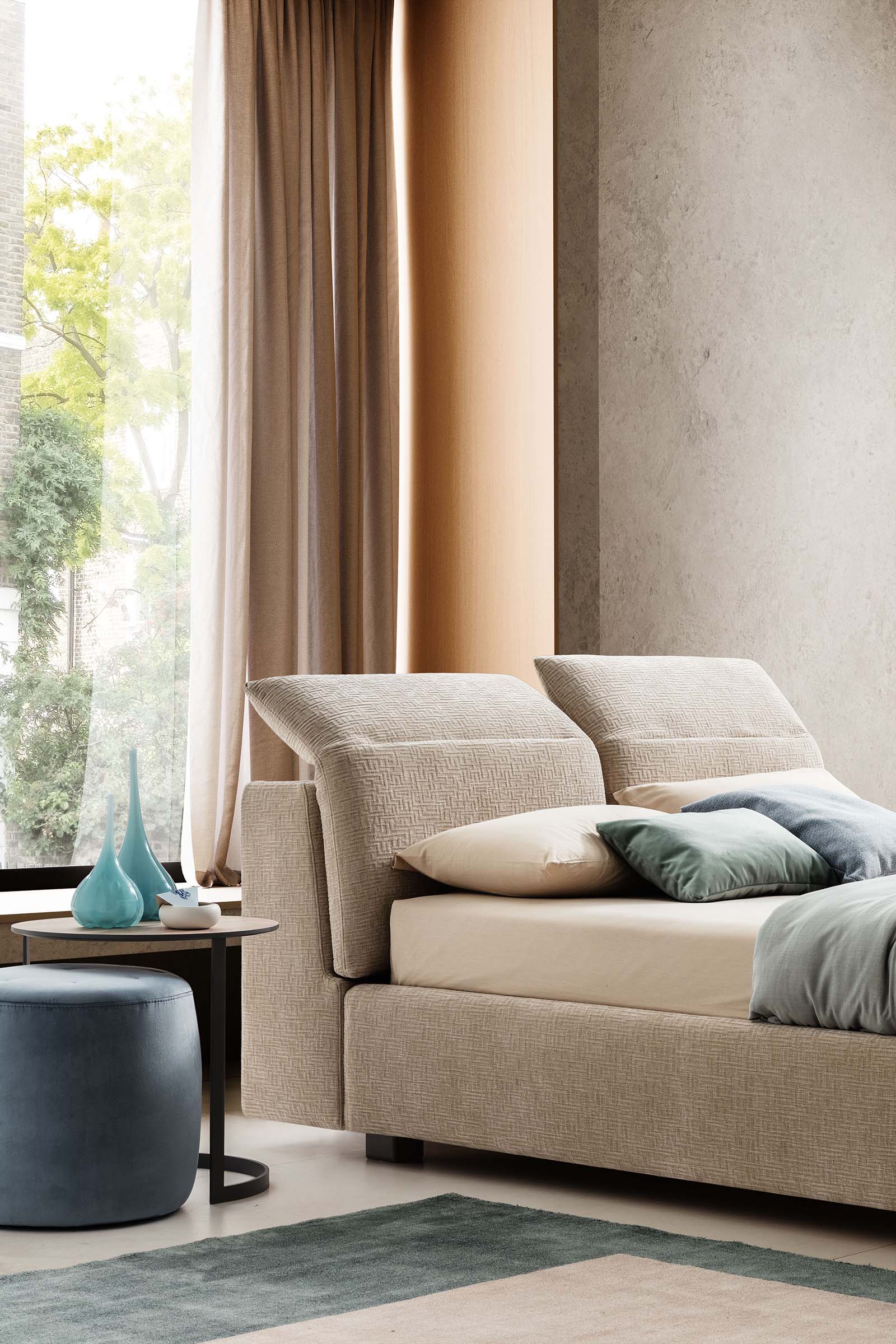 Modern double bed with adjustable headrests open in a large modern room