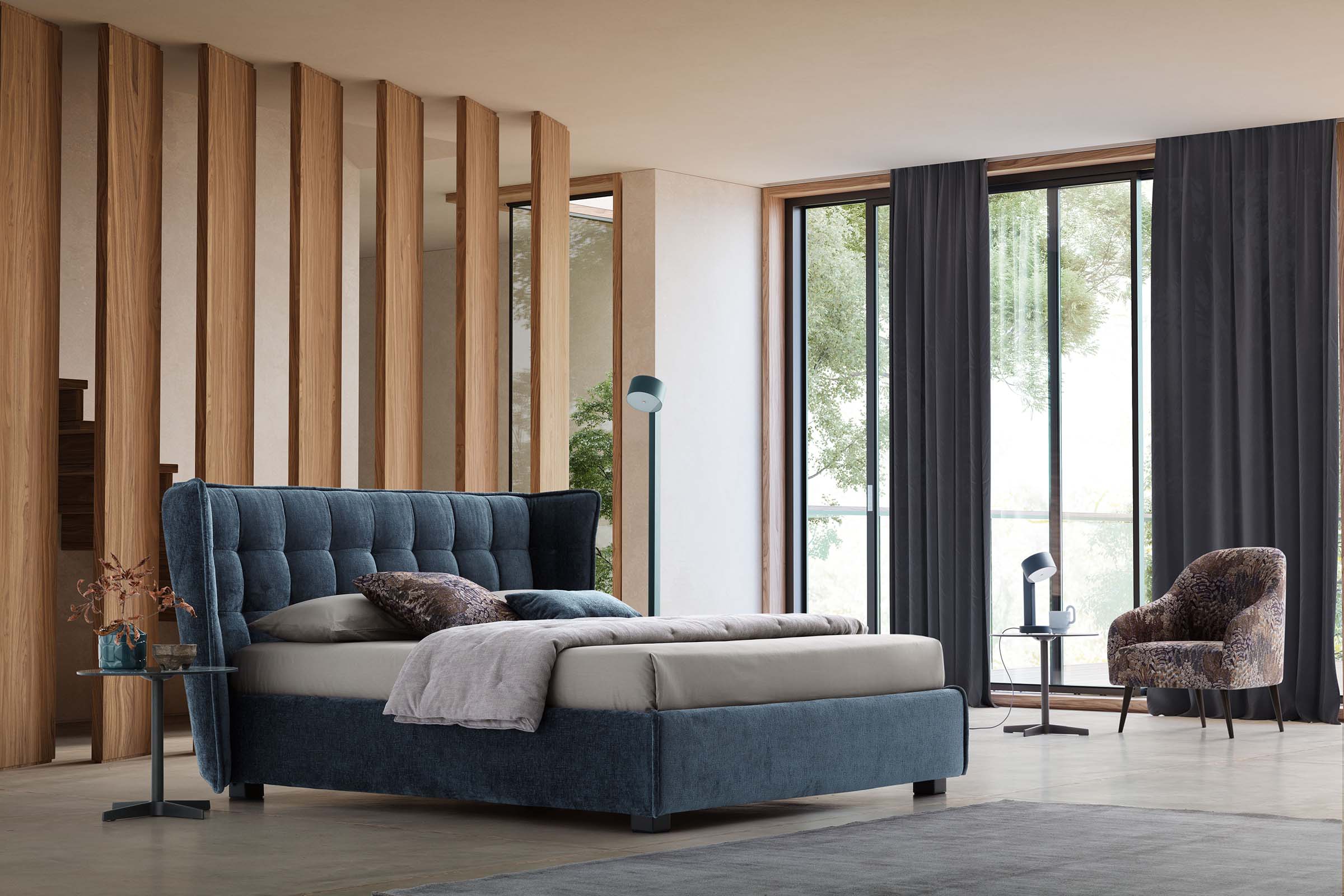 Modern bedroom furnished with an Aspen midnight blue double bed with low feet