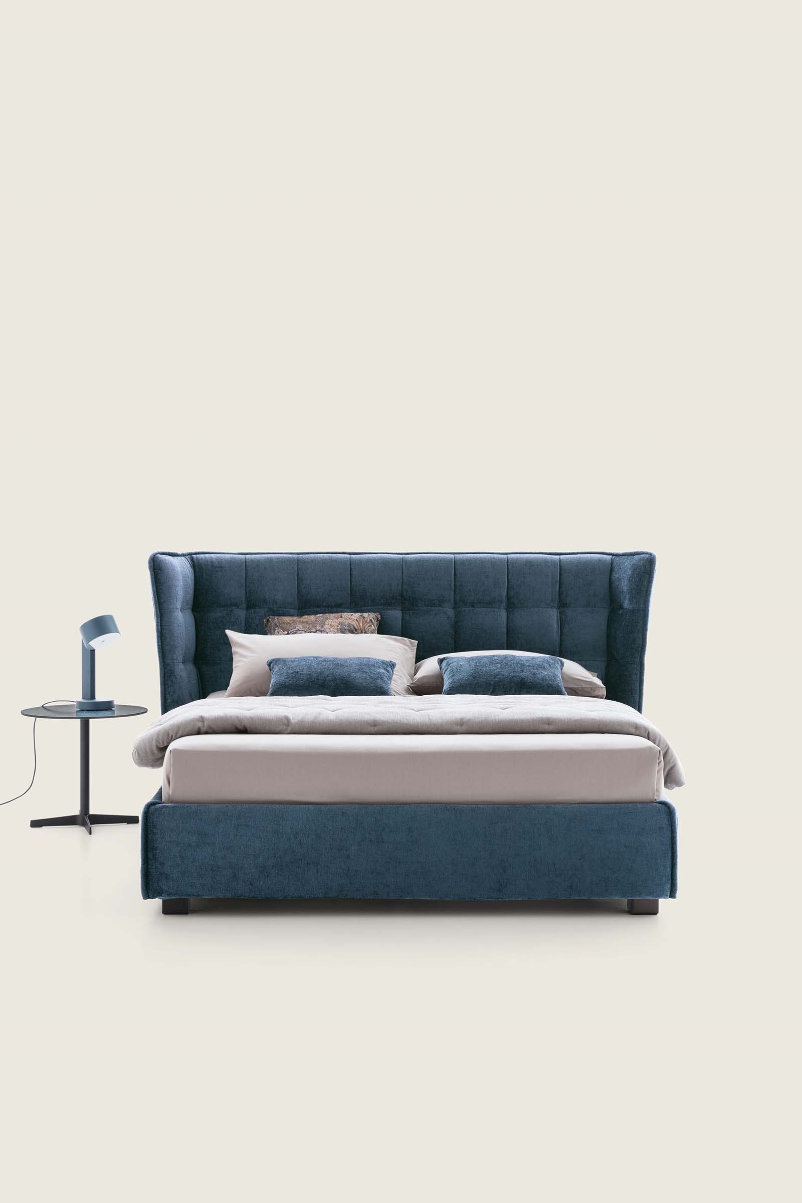 Bed with blue faux-velvet Corinne 077 upholstery and matching small table