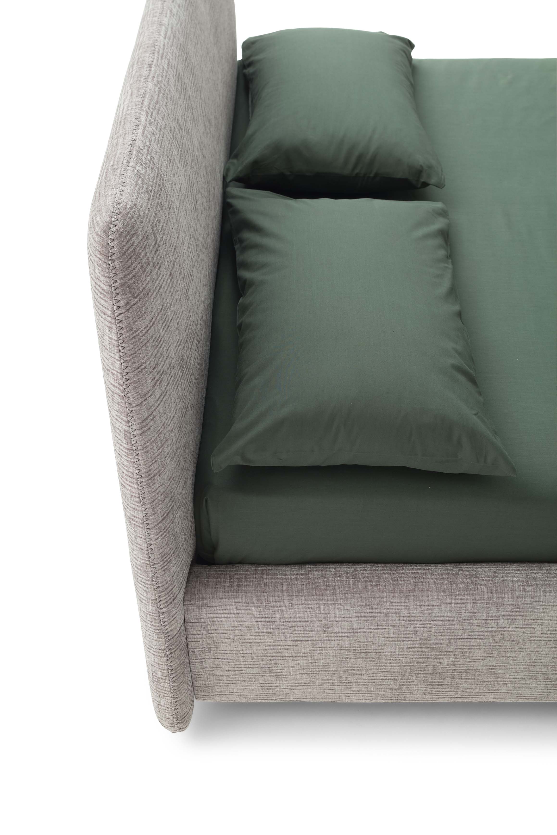 Detail of the Calvin bed headboard with green linens