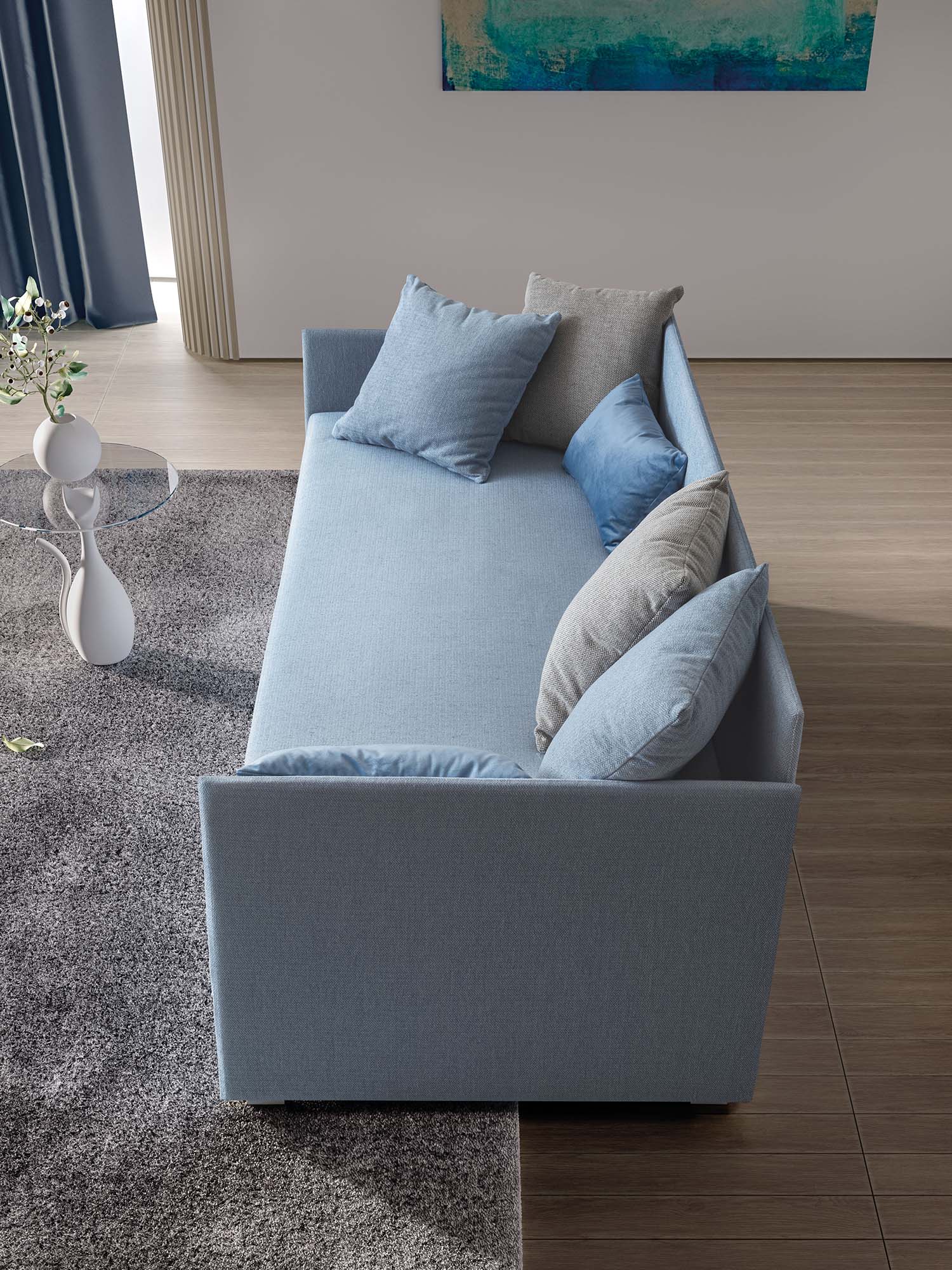 Daybed in sofa mode with a very thin structure. Pastel light blue fabric with comfortable cushions