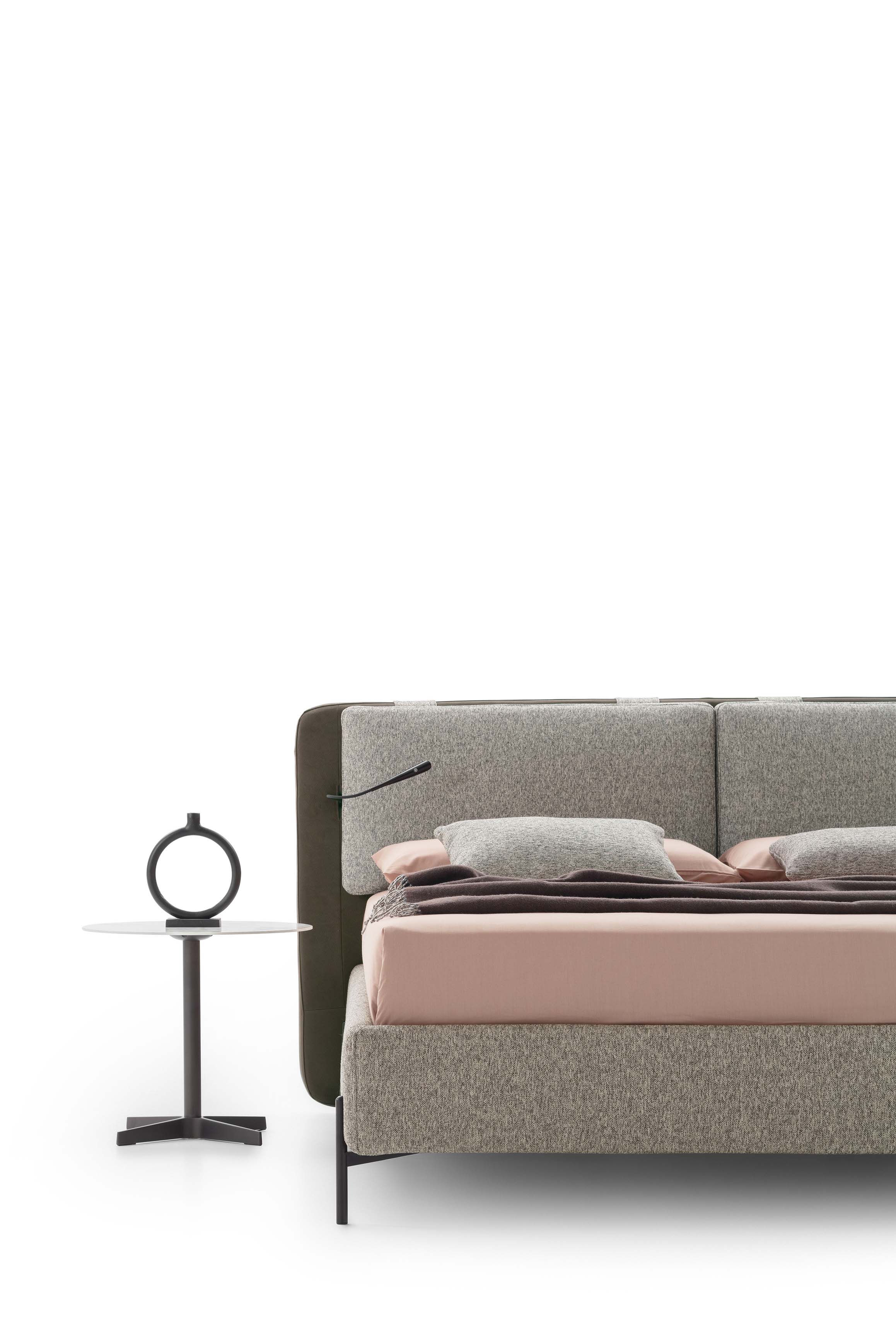 Bed with high dark painted steel feet and medium-high bed frame