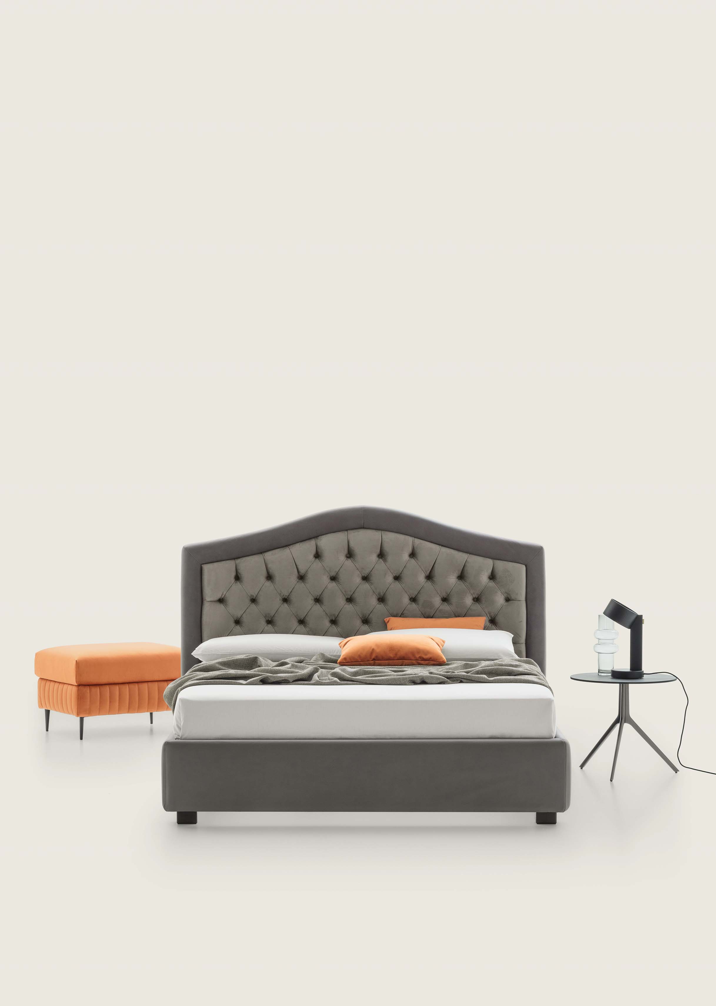 Chesterfield-style bed with two-tone gray and dark gray upholstery