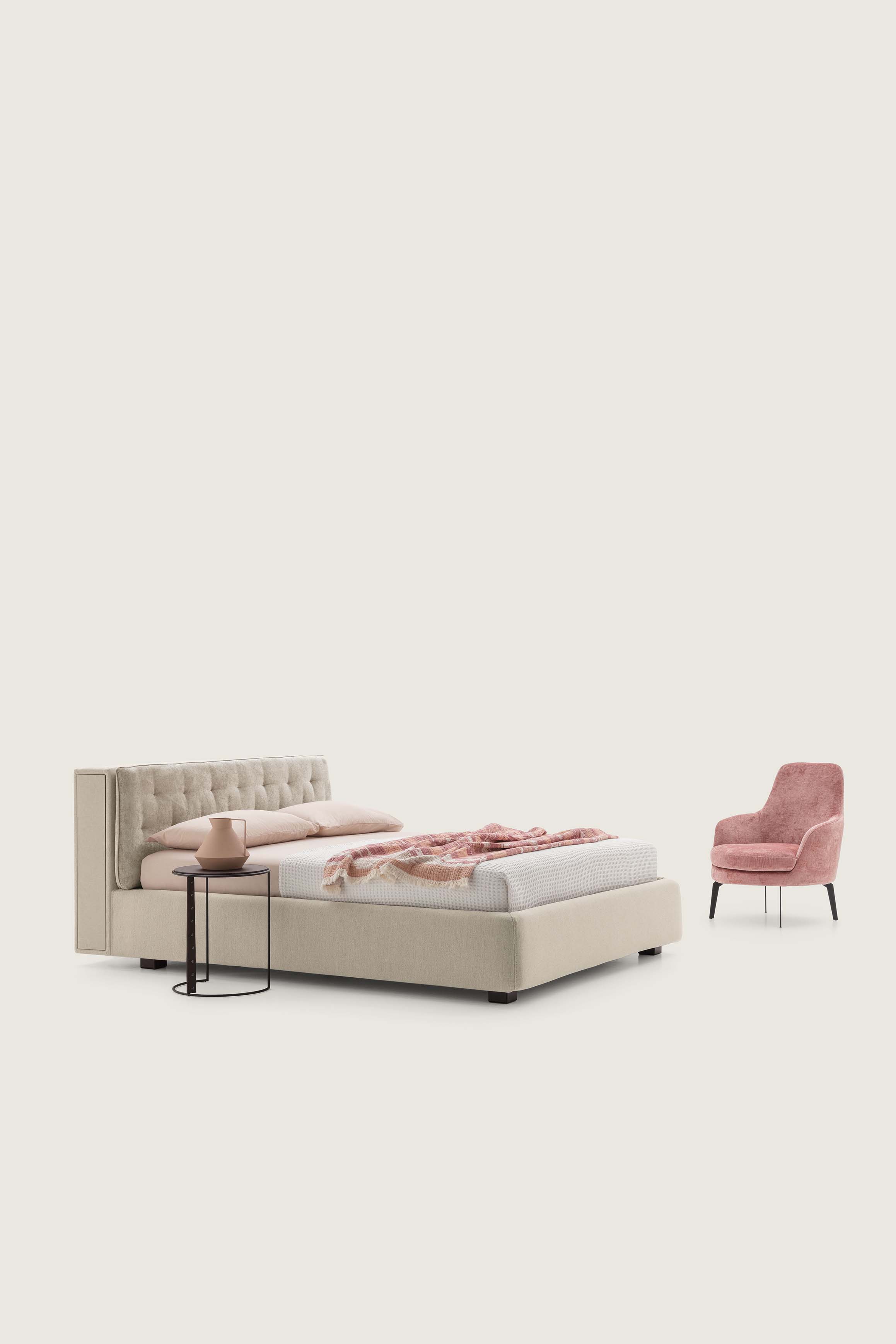 Classic bed with cream-colored capitonné upholstered headboard and pull-out bookcase