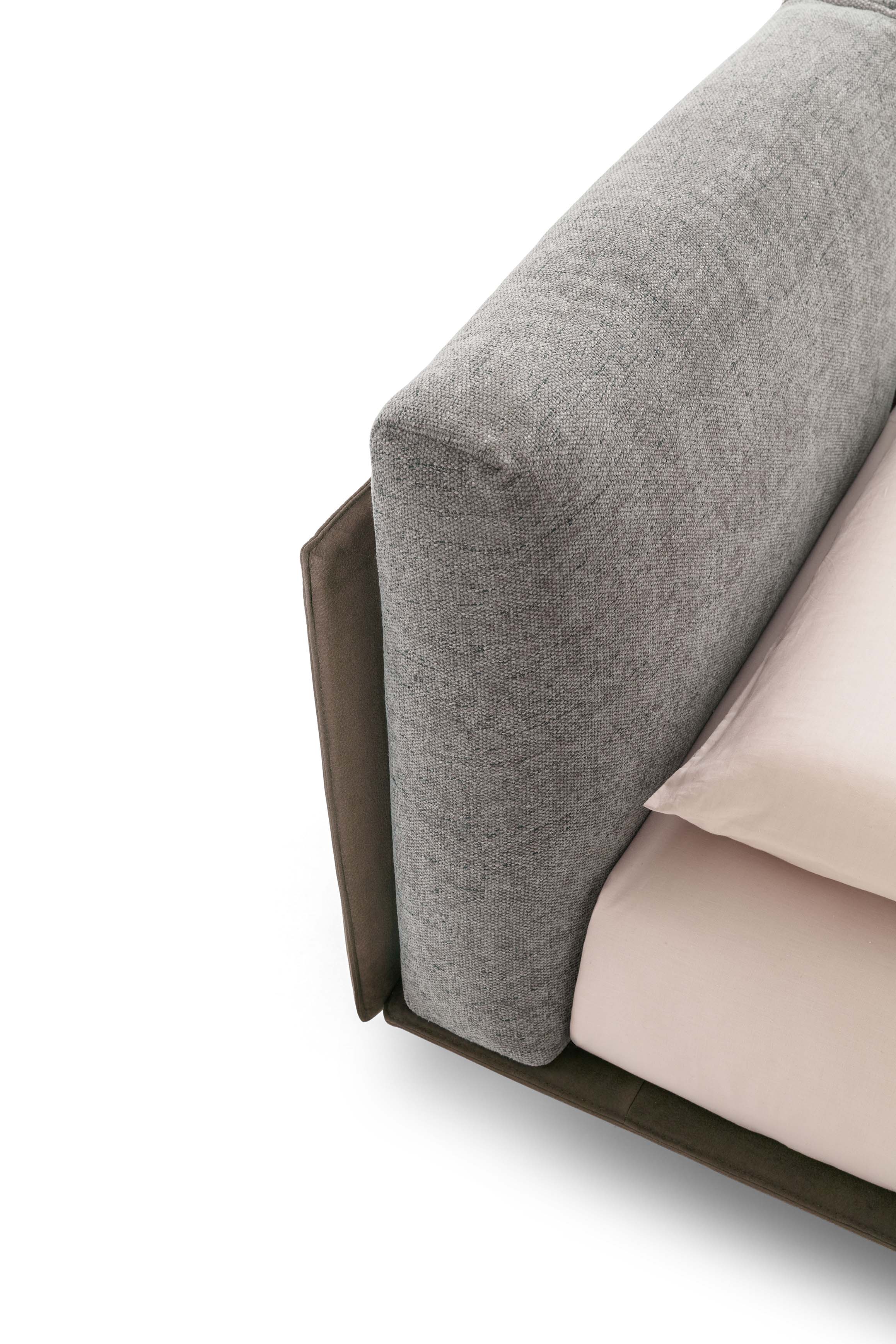 Headboard of a bed composed of cushions supported by a rigid panel