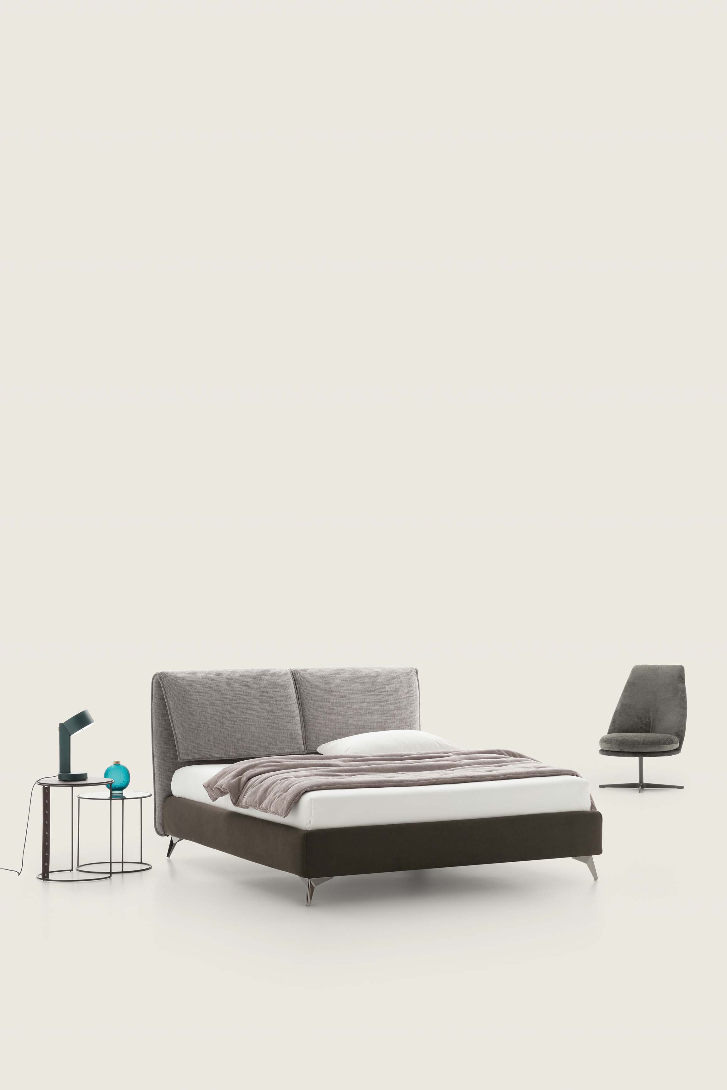 Double bed with brown bed frame and headboard with adjustable gray cushions