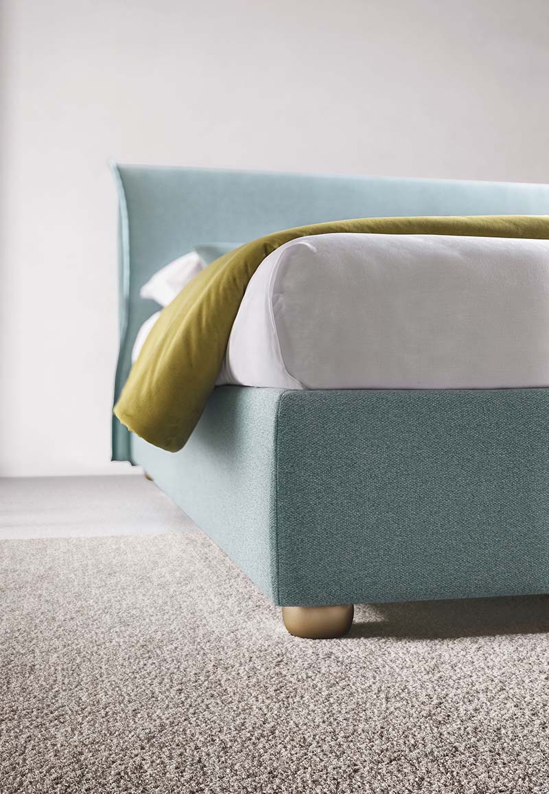 Detail of the low feet of a light blue bed