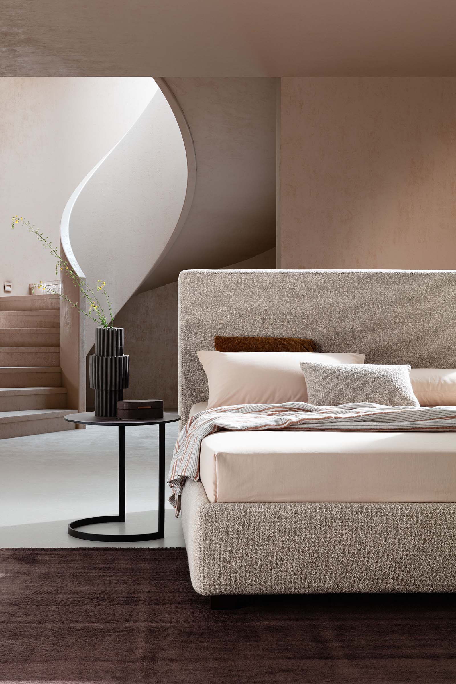 Simple modern cream-colored bed with smooth linear headboard in a modern setting