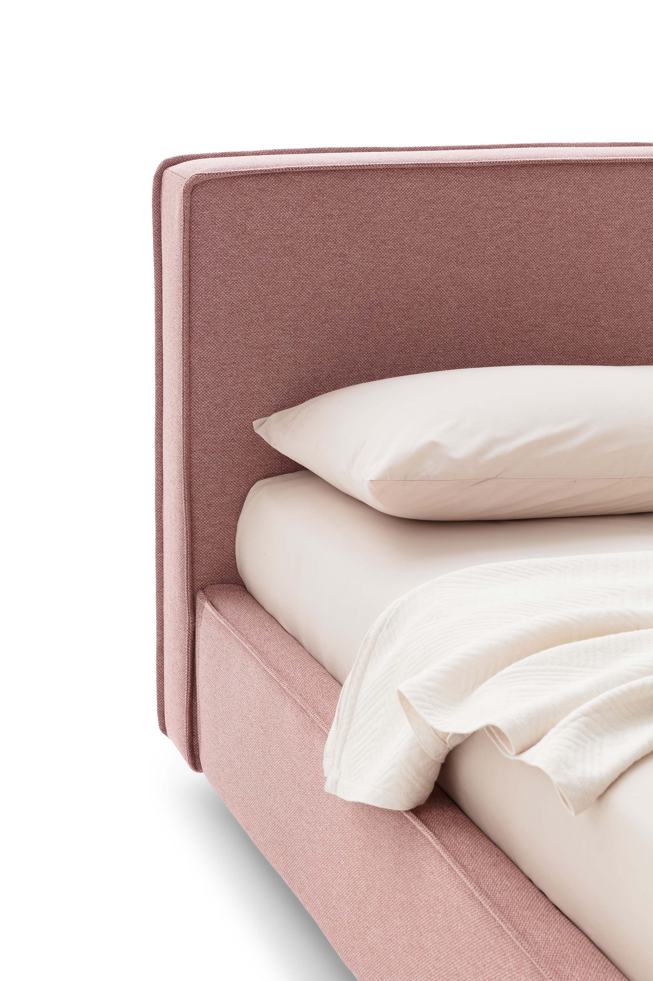 Detail of the piping of an antique pink classic-style bed